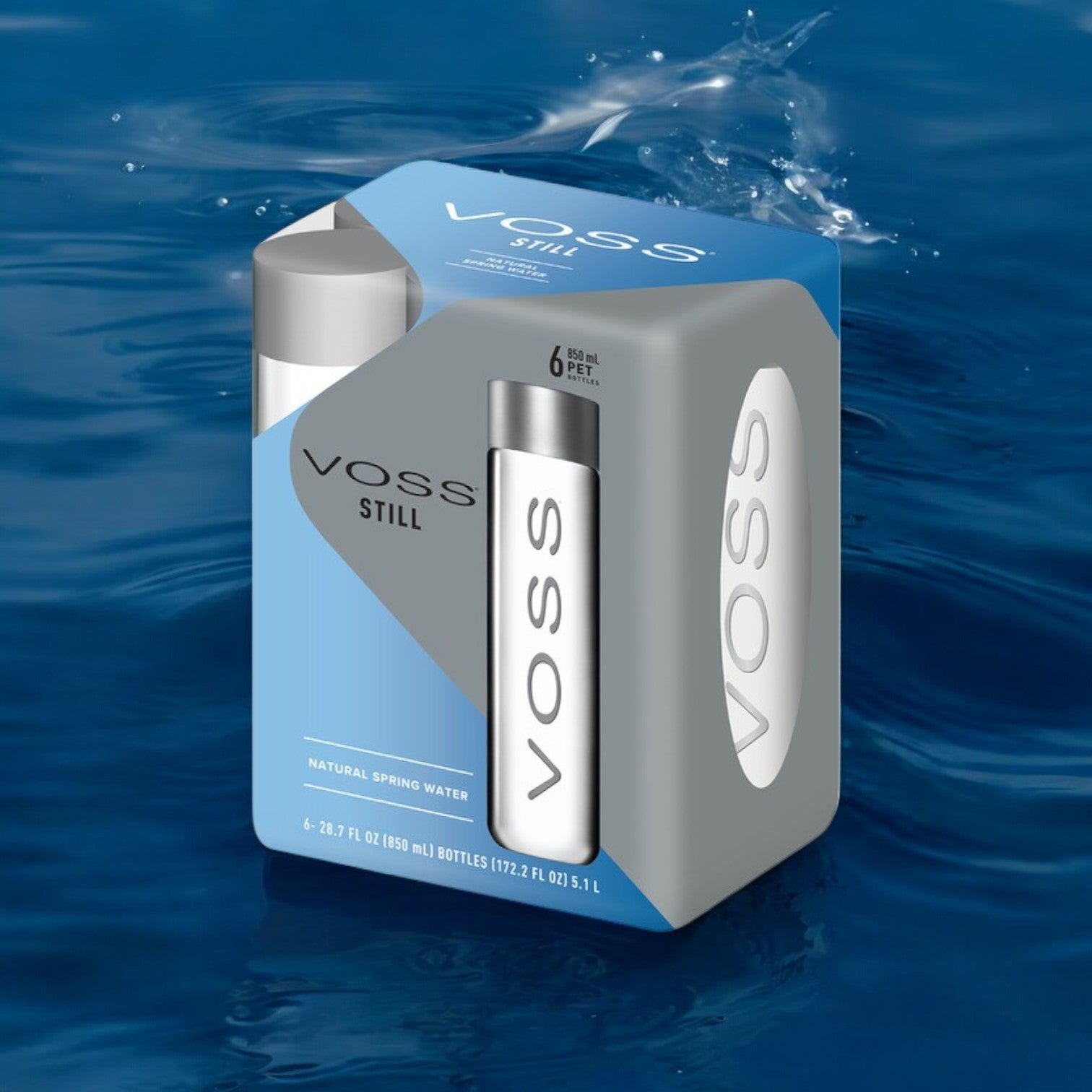 A six-pack of VOSS Still Water, 28.7 fl oz bottles by VOSS, is shown on a blue water surface, highlighting its premium packaging with clear branding and details.