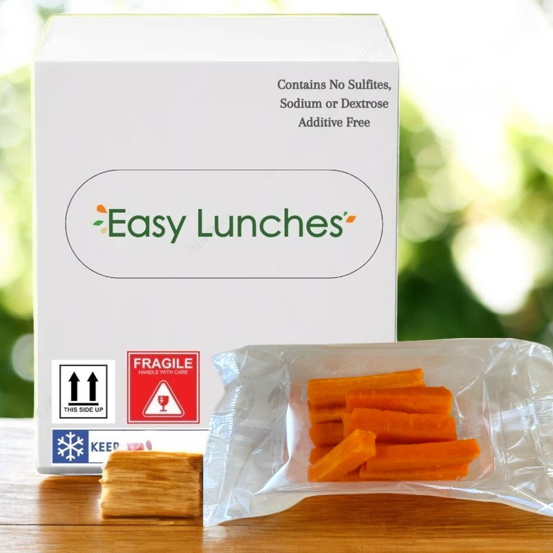 The "Easy Lunches" package with nutrition info is behind a sealed bag of carrot sticks, 2.5 oz., set against a blurry green background; known for their nutritional benefits, they are made to order and last 7 days when received.