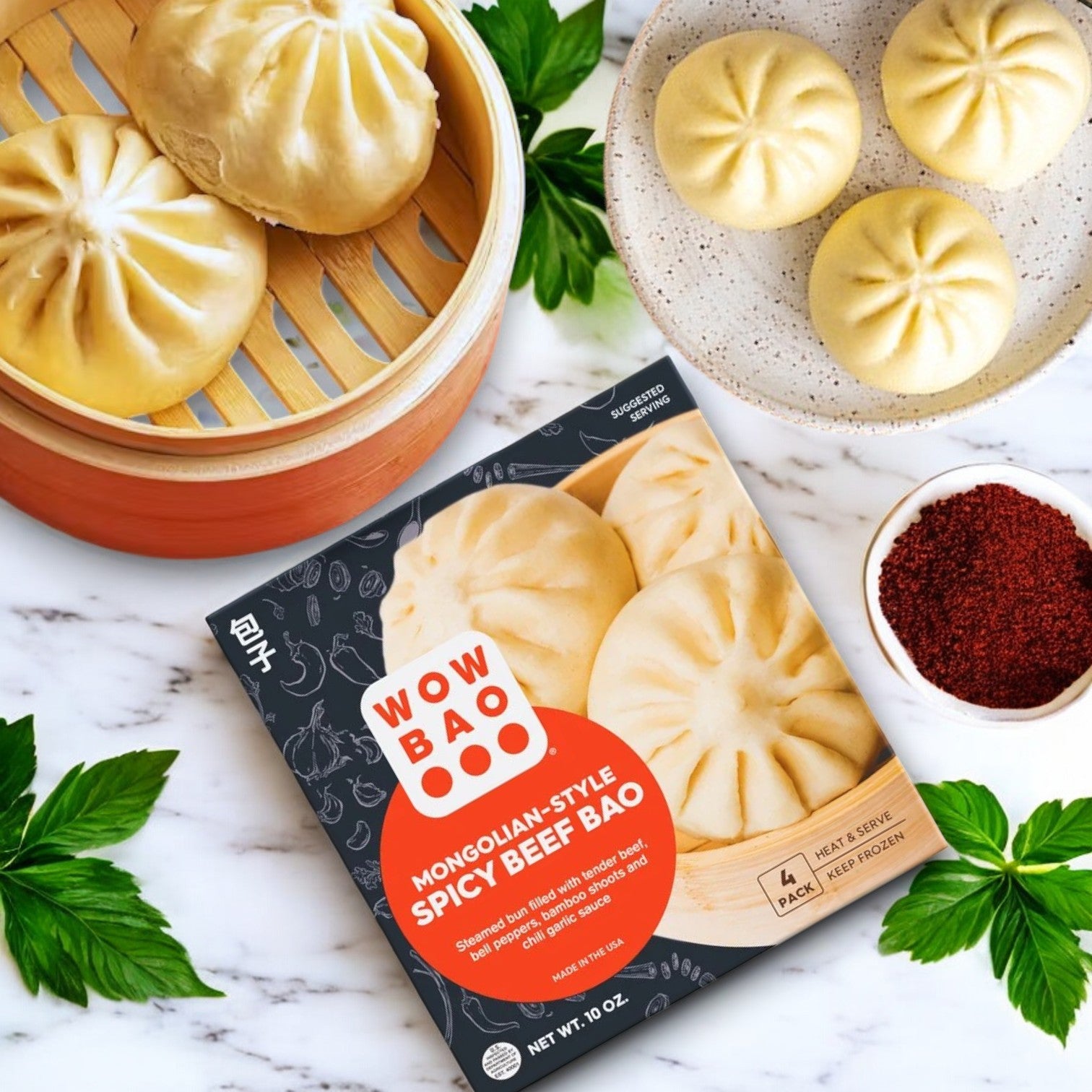 Wow Bao Mongolian-Style Spicy Beef, Bao-1 Count by Wow Bao is displayed on a marble surface with savory steamed buns, red spice, and fresh herbs, emphasizing its bold Asian-inspired flavors.