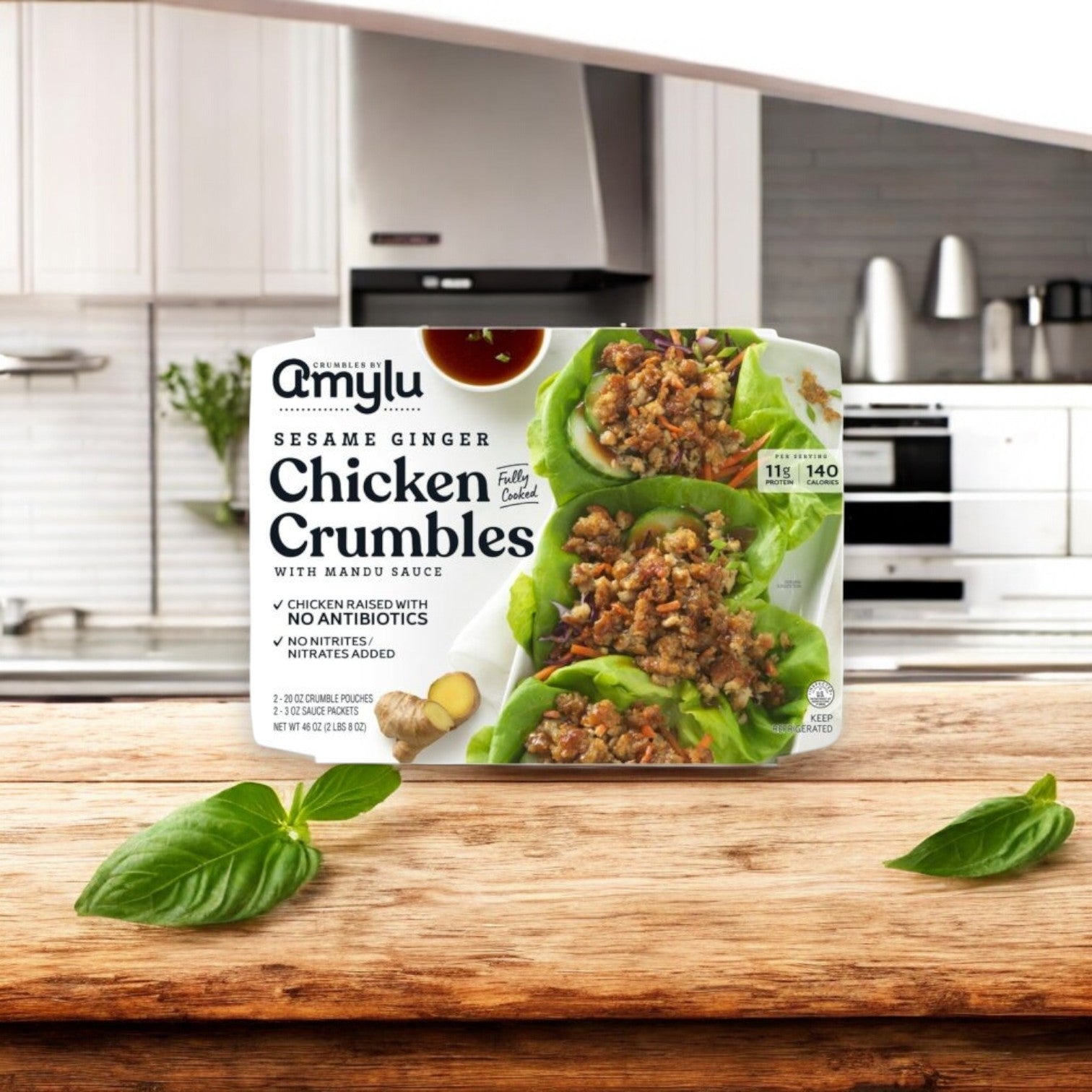 Amylu’s 4-Pack Combo – Premium Chicken & Sausage Variety is shown on a wooden surface in a modern kitchen, featuring antibiotic-free chicken and lettuce wraps on the packaging.