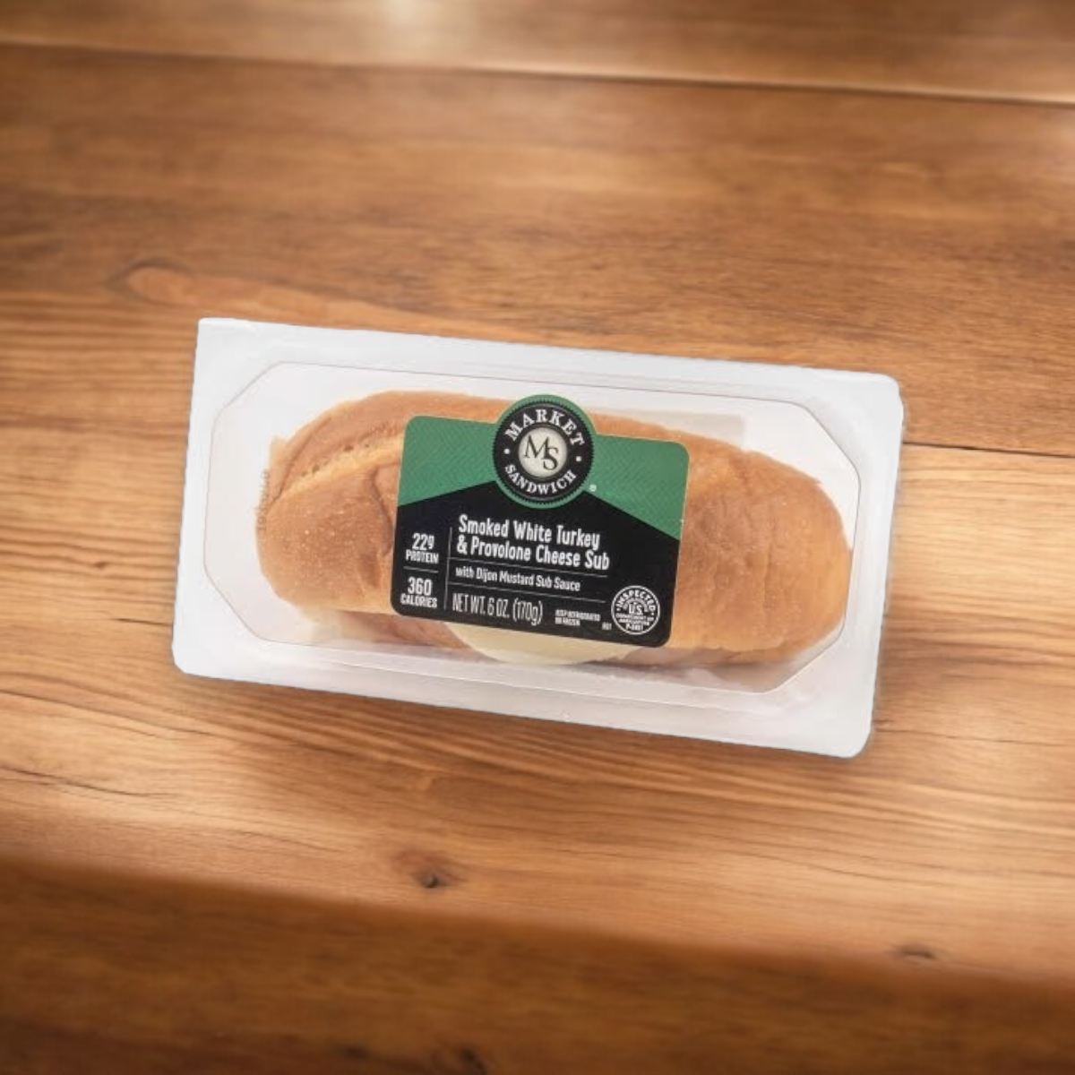 An E.A. Sween Smoked White Turkey & Provolone Cheese Sub, from a case of 8, is shown on a wooden surface; it ships frozen and has a 30-day shelf life in the cooler after thawing.