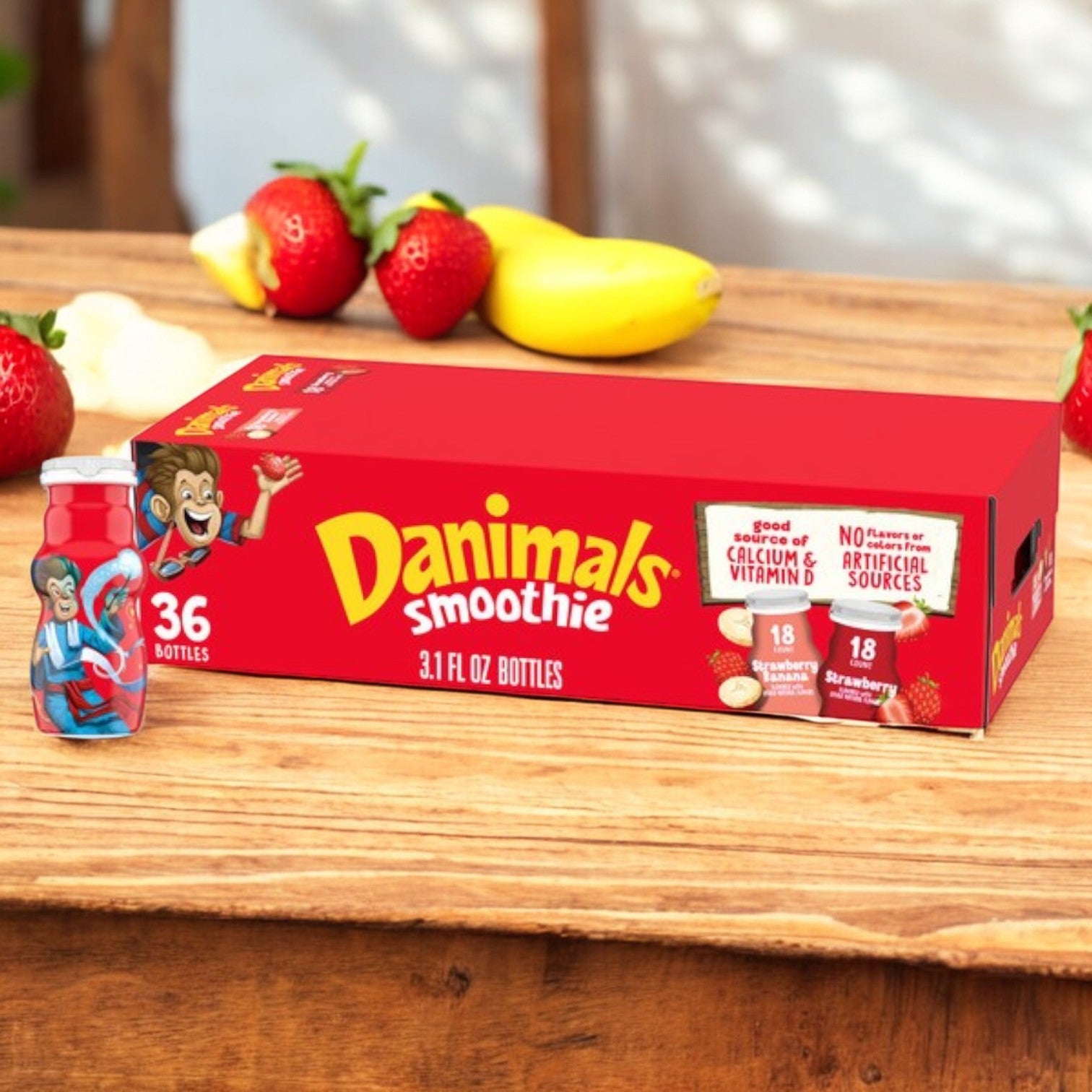 The Dannon Danimals Smoothies Strawberry Variety Pack features 36 bottles, 3.1 oz each, in a vibrant red box with cartoon characters and fruit designs. It highlights calcium, Vitamin D, and no artificial flavors—making it a nutritious snack for kids.