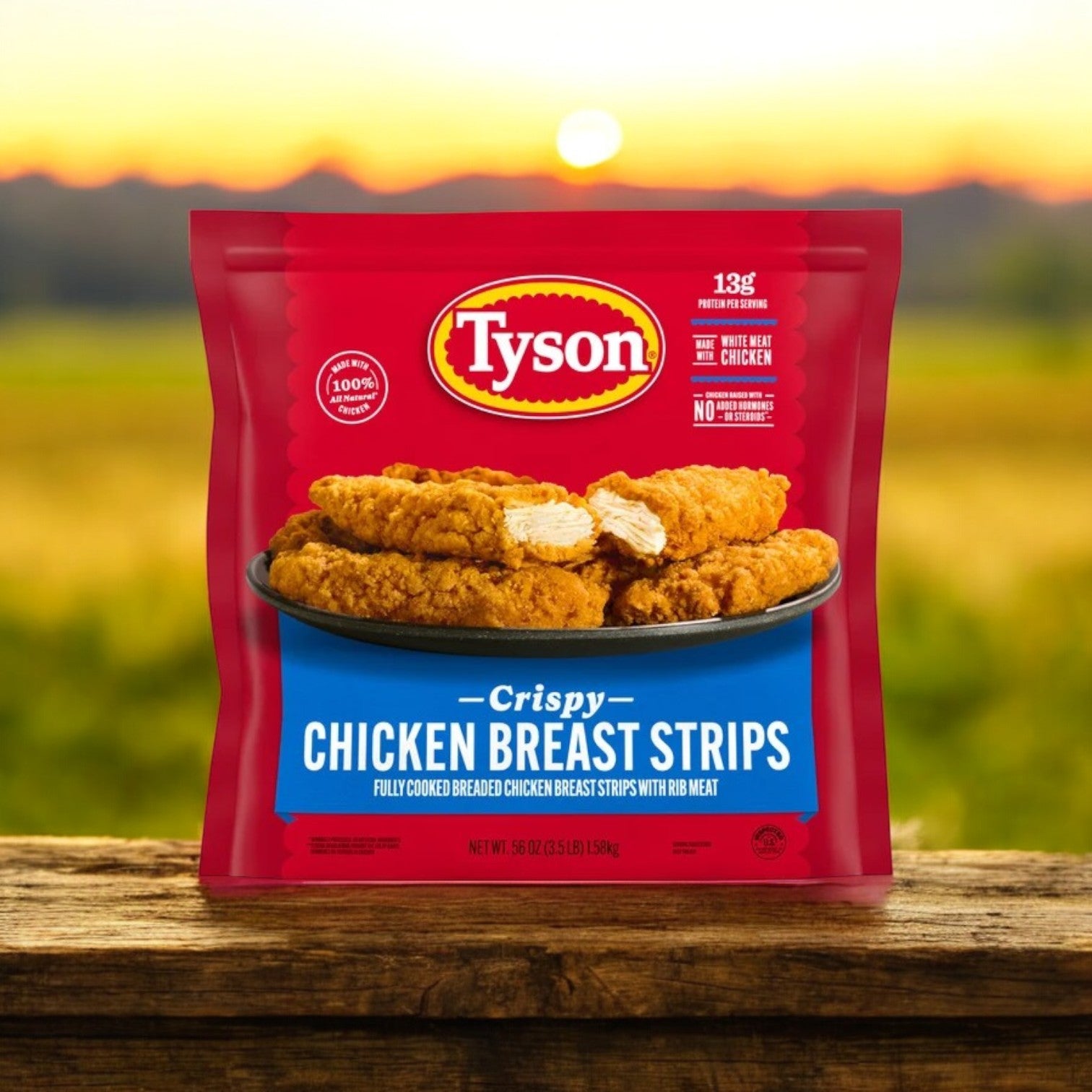 Tyson Fully Cooked Crispy Chicken Strips, 3.5 lbs. - 3 Bag on a wooden surface with a natural landscape blurred in the background—a perfect quick meal for any occasion.