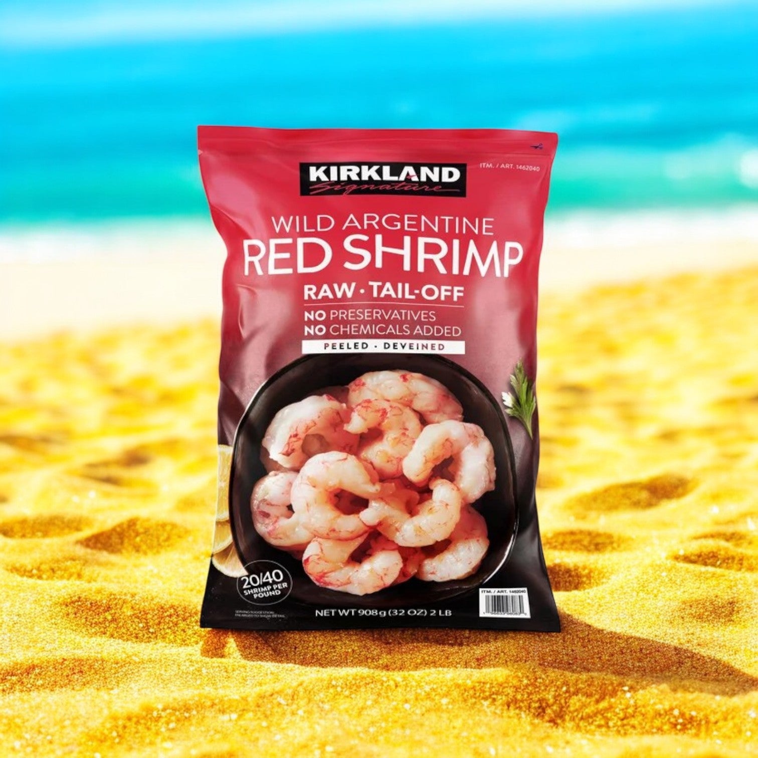 A bag of Easy Lunches Kirkland Signature Argentine Red Shrimp (20/40 per lb, 2 lbs, 3 bags, 6 lbs total) rests on yellow sand, filled with wild-caught shrimp and the blurred ocean and sky in the background.