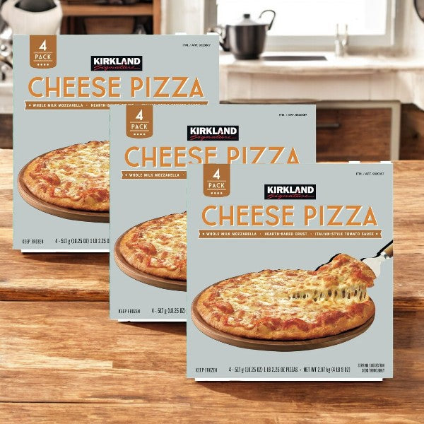 Three boxes of Easy Lunches Kirkland Signature Cheese Pizza, 4-count - 3 Packs are displayed on a wooden kitchen counter, with kitchen utensils and a sink visible in the background.