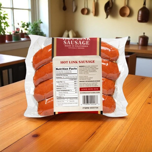 A vacuum-sealed pack of Easy Lunches Evergood Louisiana Brand Hot Link Sausage (36 Links, 9 lbs-3 Packs) rests on a wooden table with nutrition facts and label visible; kitchen utensils hang behind, hinting at its spicy kick.