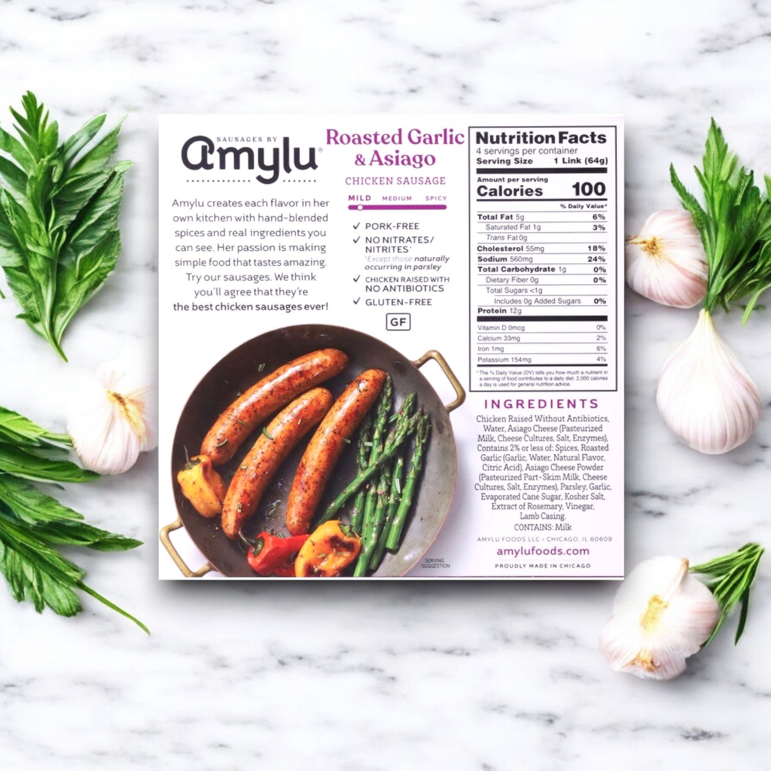Packaging for Amylu Roasted Garlic & Asiago Chicken Sausage - 3 Packs, shown on marble with herbs, features ingredients, nutritional info, and a skillet image.