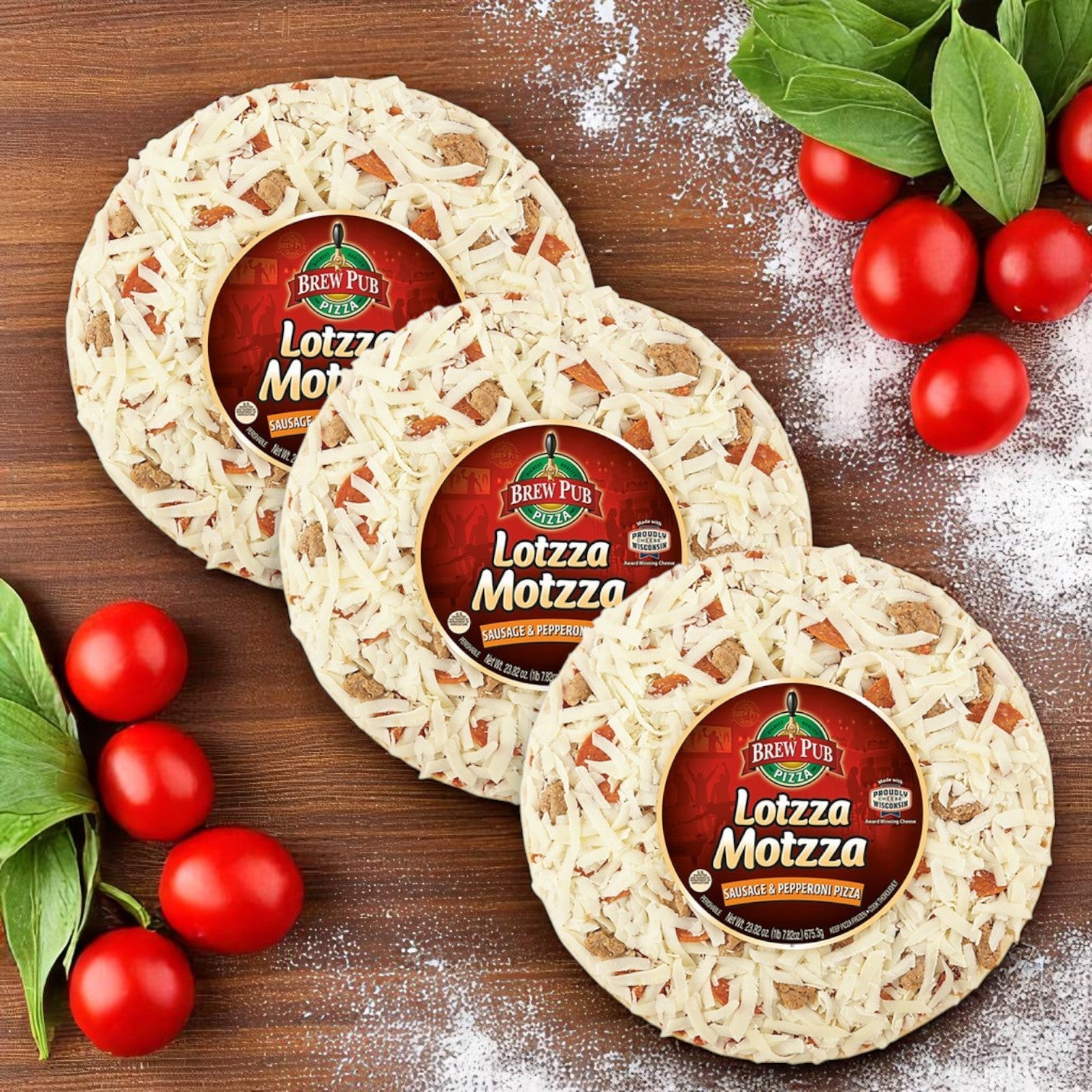 Three Bernatello's Brew Pub Pizza – Sausage & Pepperoni (3-Pack, 23.82 oz each) are displayed on a wooden surface with cherry tomatoes, basil, and flour for an authentic pub-style crust experience.