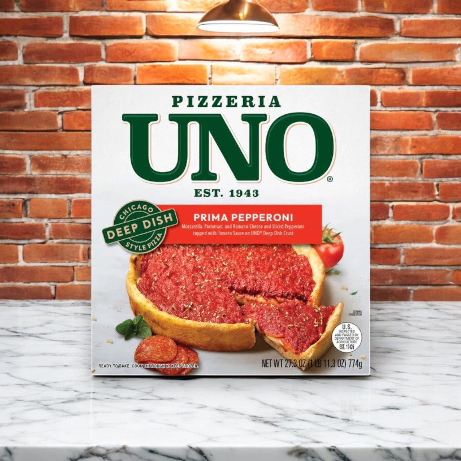 Box of Chicago's Deep Dish Mix! by Easy Lunches, featuring a slice of Prima Pepperoni deep dish pizza with thick tomato and pepperoni layers, set against a rustic brick wall. Ideal for those craving an authentic Chicago-style experience with 4 total pizzas included.