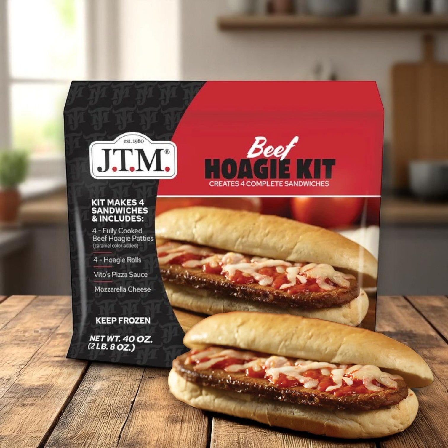J.T.M. Beef Hoagie Kit – 2 lbs, by J.T.M, sits on a kitchen counter, showcasing the packaging with images of four complete hoagie sandwiches filled with seasoned beef, sauce, and cheese.