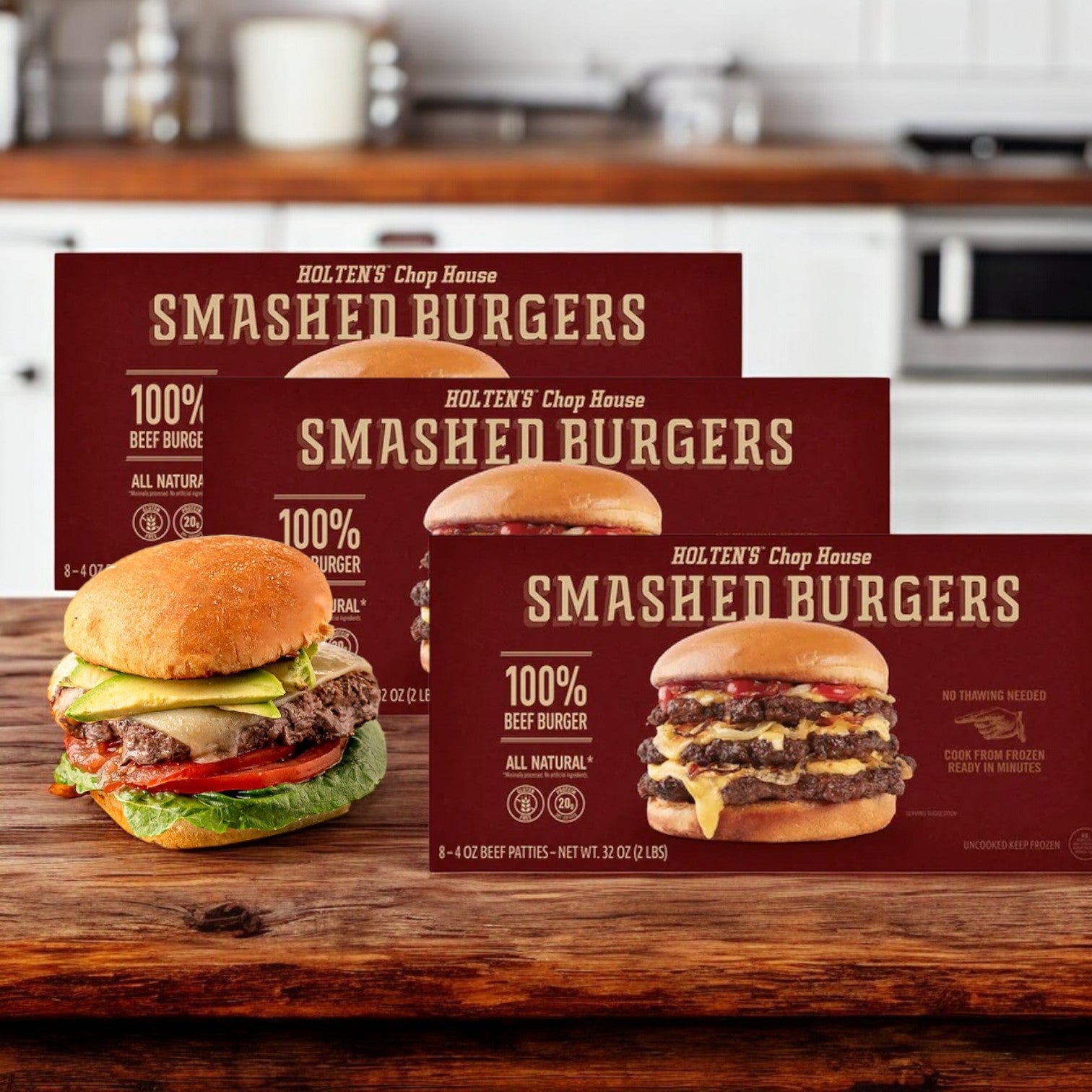 Three boxes of Holten's Chop House Steak Burgers Certified Angus Beef- 3 Count sit on a wooden counter, with a premium burger displayed in front of them.
