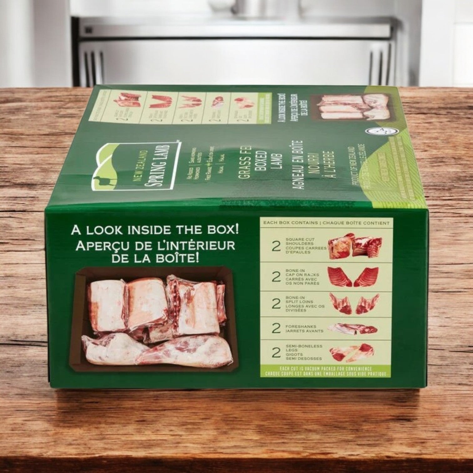 A green box labeled "New Zealand Spring Lamb" sits on a kitchen counter, displaying Halal Lamb Carcass, 8-Way Cut, 28 lb avg wt with contents listed in English and French.