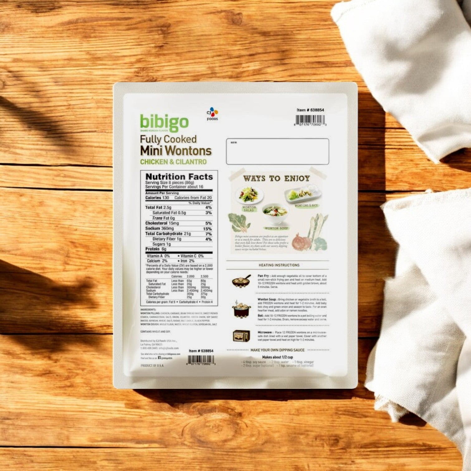 Bibigo Mini Wontons – Chicken & Cilantro (3 lbs) package by Bibigo with nutrition facts, cooking instructions, and serving suggestions shown on the back, placed on a wooden surface with napkins.