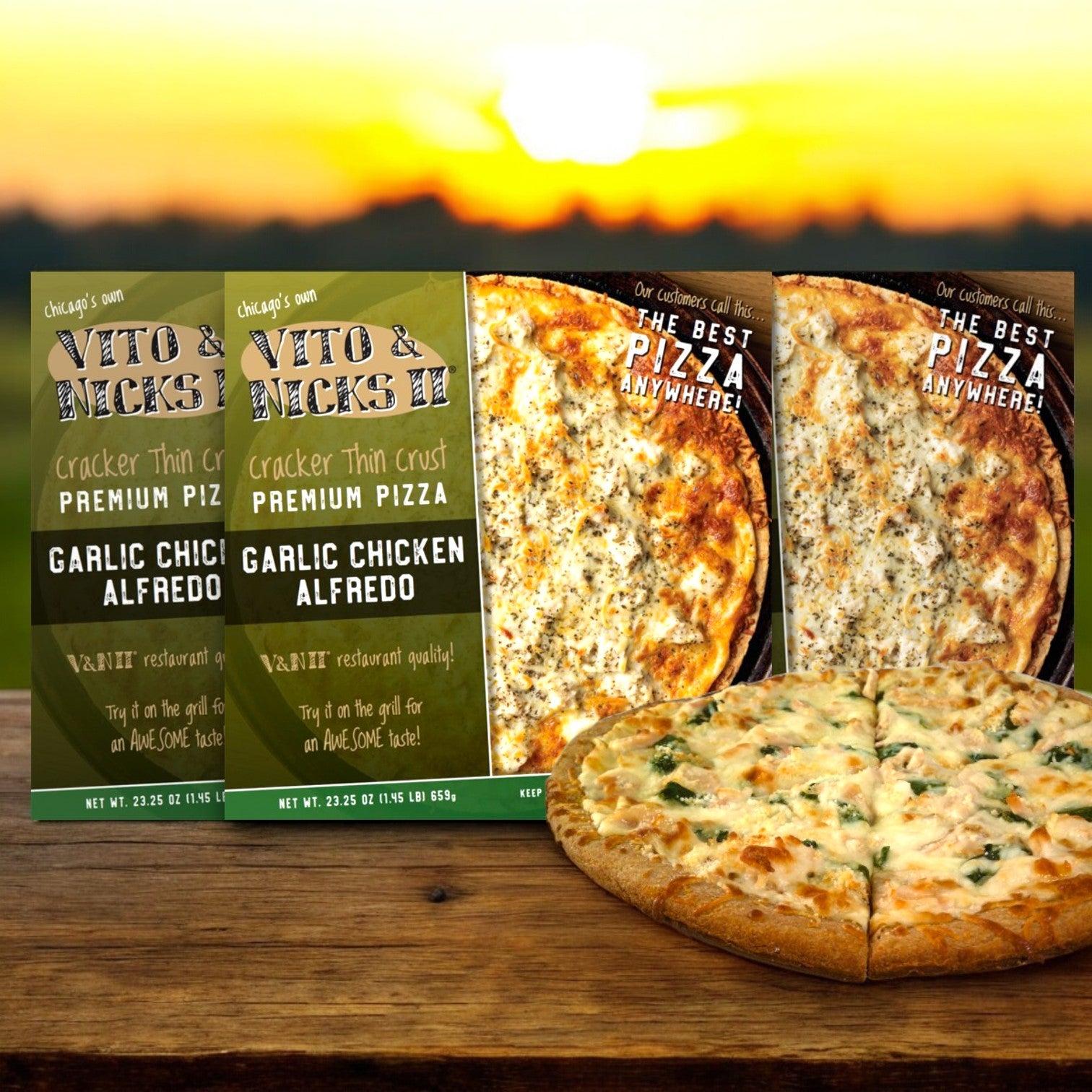 At sunset, two boxes of Vito & Nick's II Cracker Thin Crust Garlic Chicken Alfredo Pizza, 23.25 oz.- 3 Count, are displayed outdoors with a cooked Chicago tavern-style pizza featuring a cracker thin crust in front.