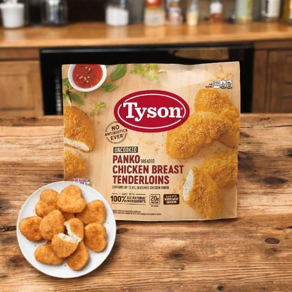 A package of Tyson Panko Breaded Chicken Breast Tenderloins, 5 lbs, on a wooden surface with a plate of served tenderloins nearby. Perfect for fast meals, these tenderloins simplify dinner time, offering ease and flavor.