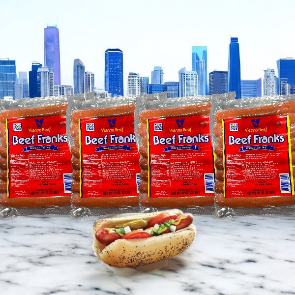 Four 32 oz packs of Vienna Beef Franks (64 total) are shown before a city skyline, with a fully cooked Vienna Beef frank in a poppy seed bun on marble in the foreground.