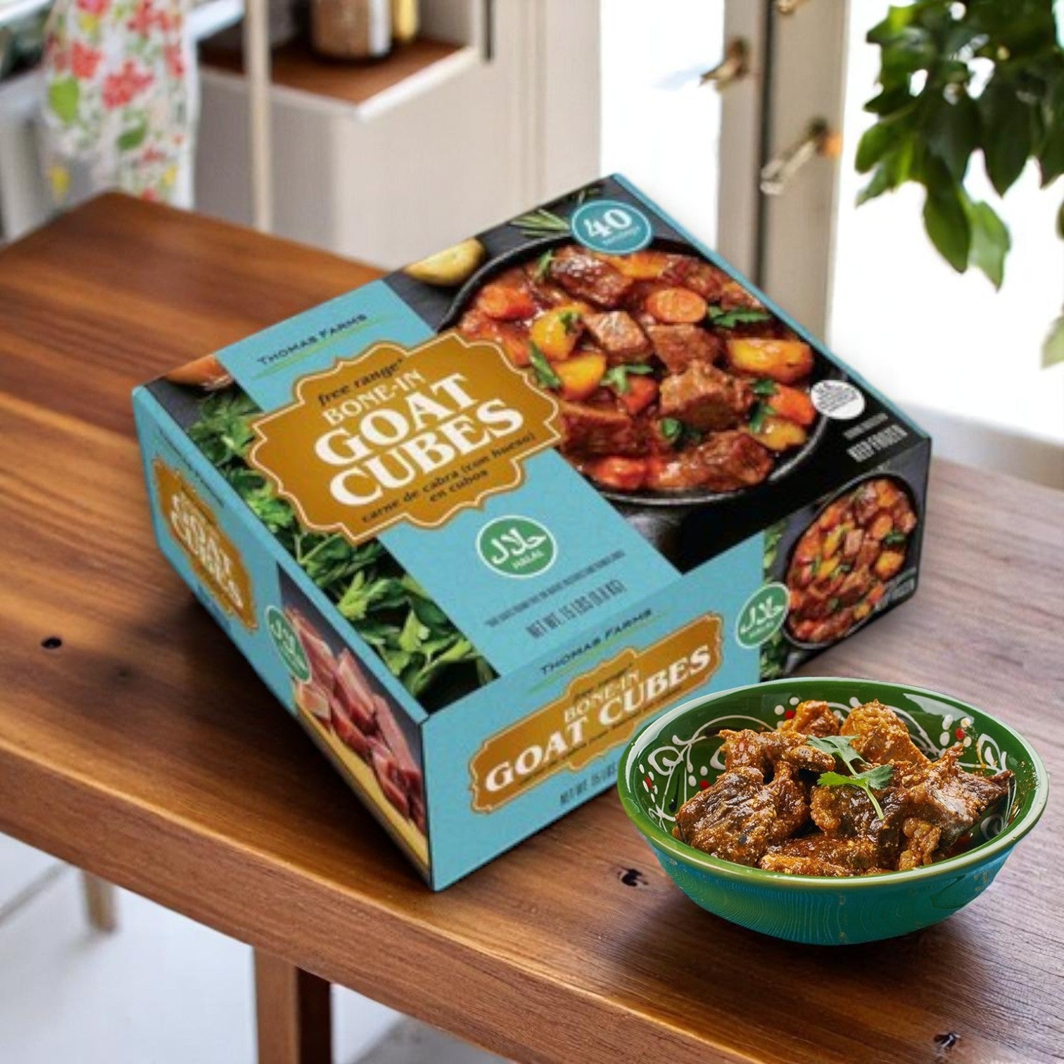 A Thomas Farms 2-Pack Halal Meat Bundle—15 lbs goat and 15 lbs lamb (bone-in)—is boxed on a wooden table next to a bowl of savory cooked goat stew.
