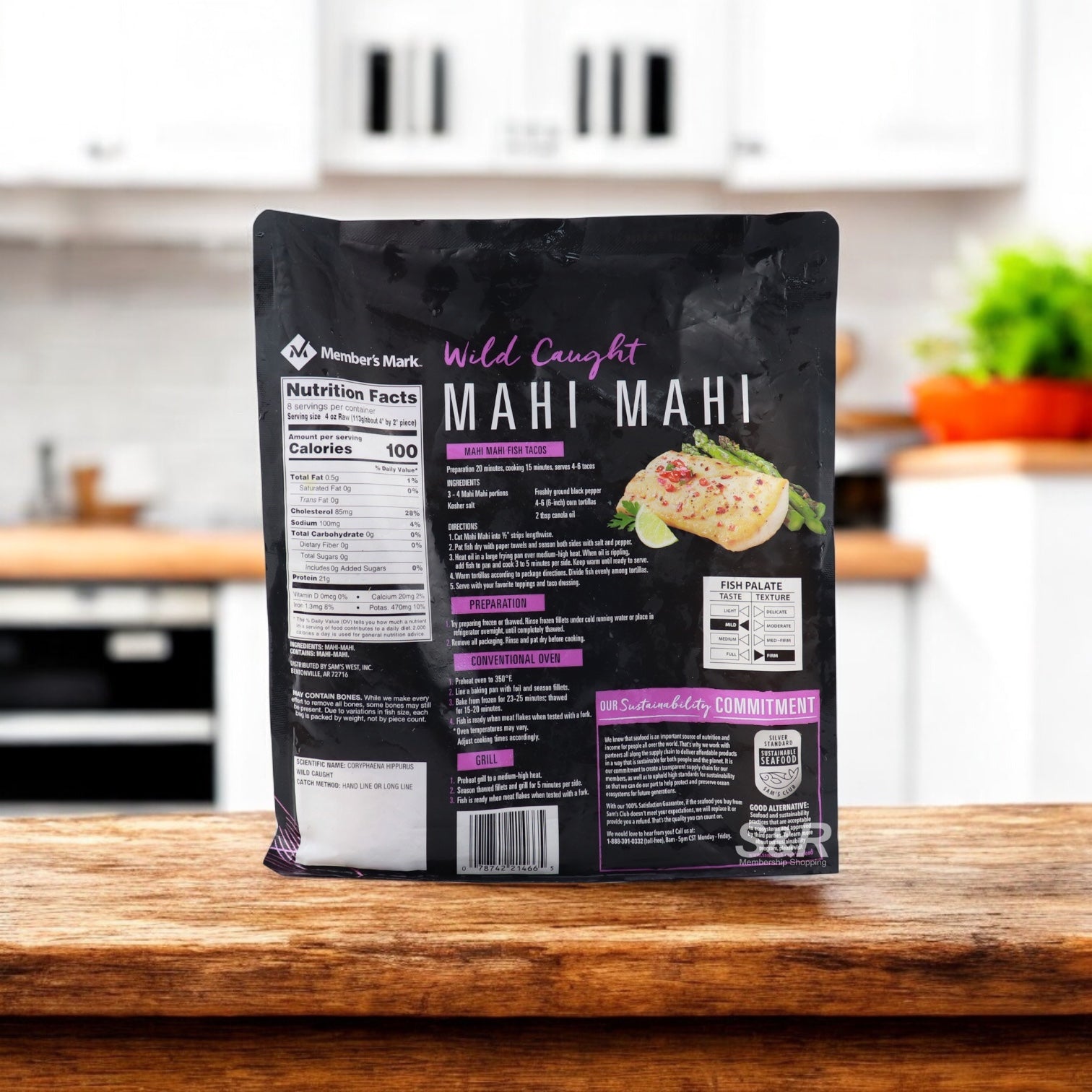 A 2-lb bag of Member's Mark Wild Caught Mahi Mahi Portions—skinless, boneless, and frozen—rests on a kitchen counter, featuring nutrition facts and prep instructions on the back.