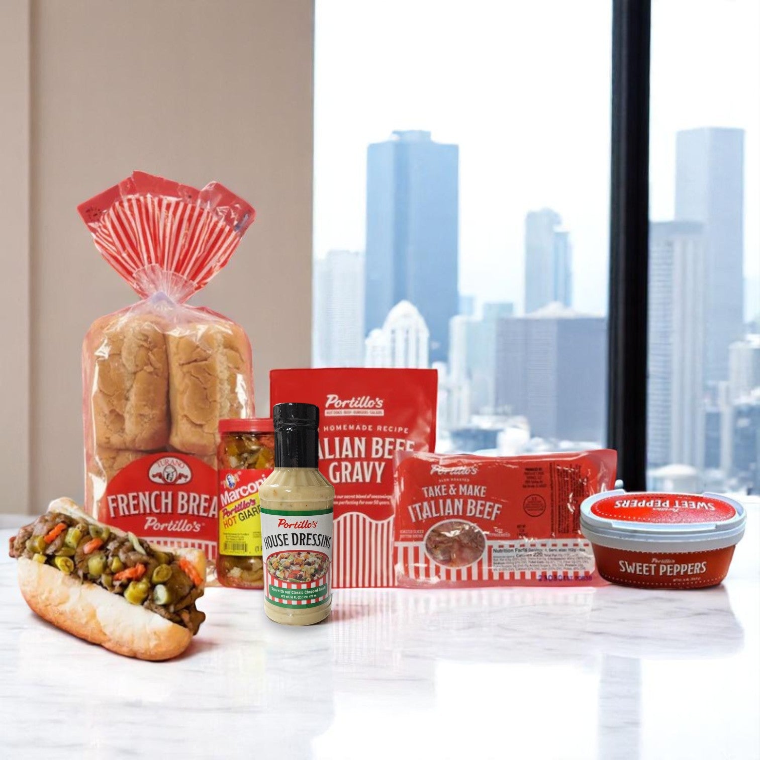The Portillo’s Italian Beef Bundle by Portillo's includes tender beef, signature gravy, sweet peppers, hot giardiniera, and fresh bread—plus Portillo’s House Dressing—all served with a city skyline in the background.