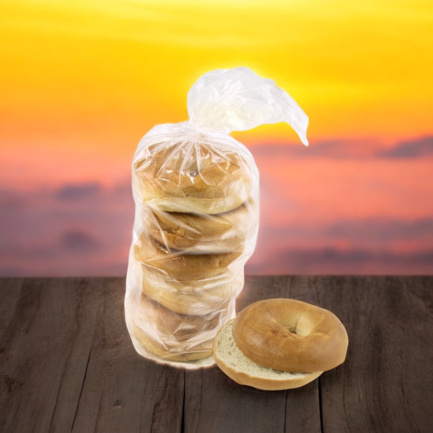 Eight packs of eight Lender's Bagel Classic Brat & Sausage Hinged Buns, with one bun outside a pack on a wooden surface and a sunset sky blurred in the background.