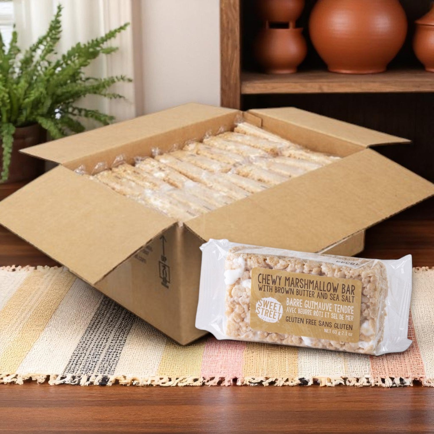 A box of Sweet Street Dessert Bar Marshmallow, 2.1 oz. (1 case, 40 bars), sits on a table with one individually wrapped bar displayed in front of it.