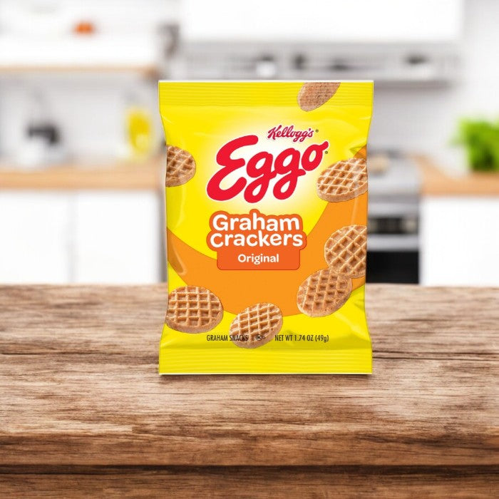 A box of Kellogg's Cracker Graham Eggo Waffle's - 10 Count sits on a wooden surface, bringing the classic Eggo taste to your kitchen for a delicious breakfast treat.