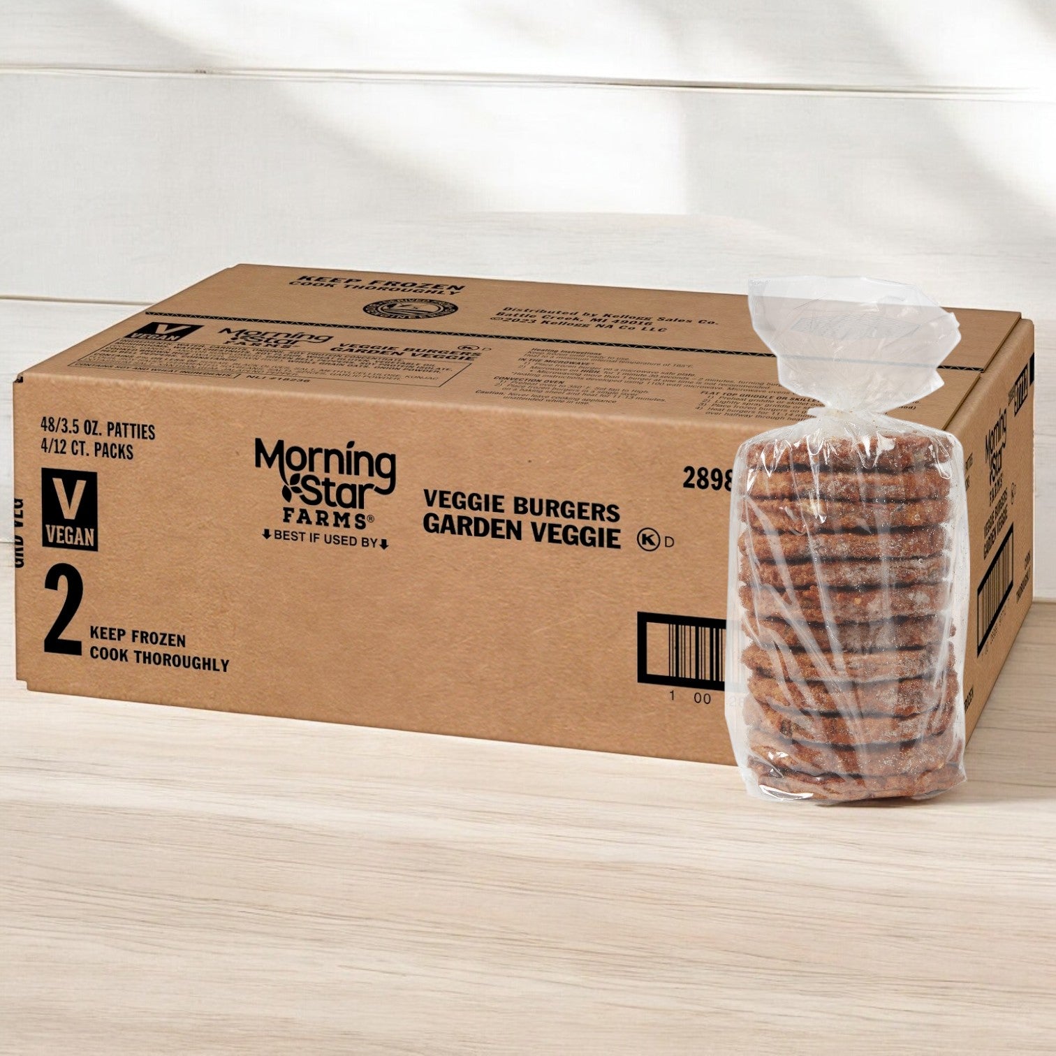 A box of MorningStar Farms Garden Burger, featuring 48 packs of 3.5 oz vegetarian patties, sits beside a clear package on a light surface, ready to elevate your plant-based burger experience.