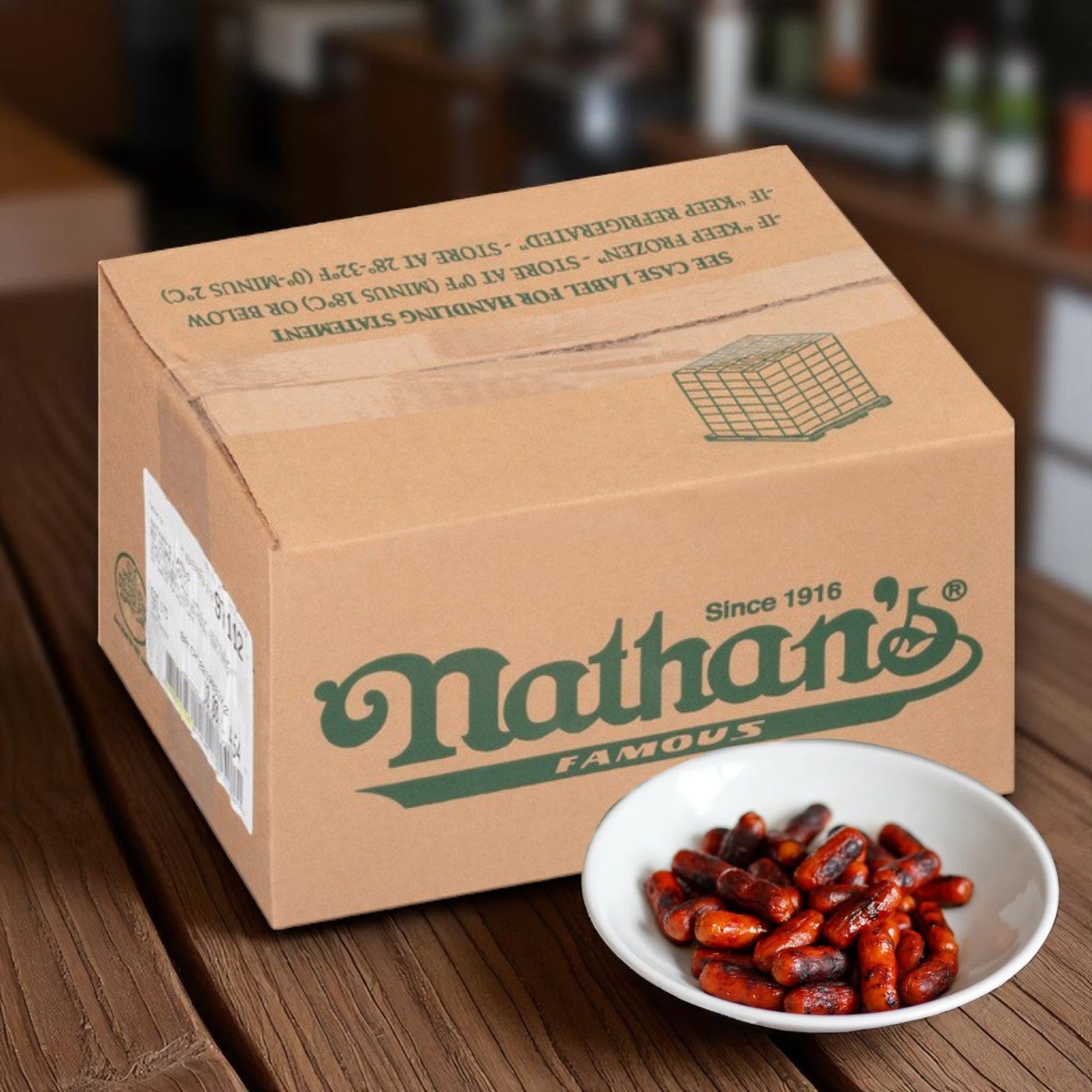 A Nathan's Famous box rests on a wooden table beside a white bowl of red beans, ready to pair perfectly with Nathan’s Famous Cocktail Franks – 1200 Count, 1 Case – premium 100% beef mini franks.