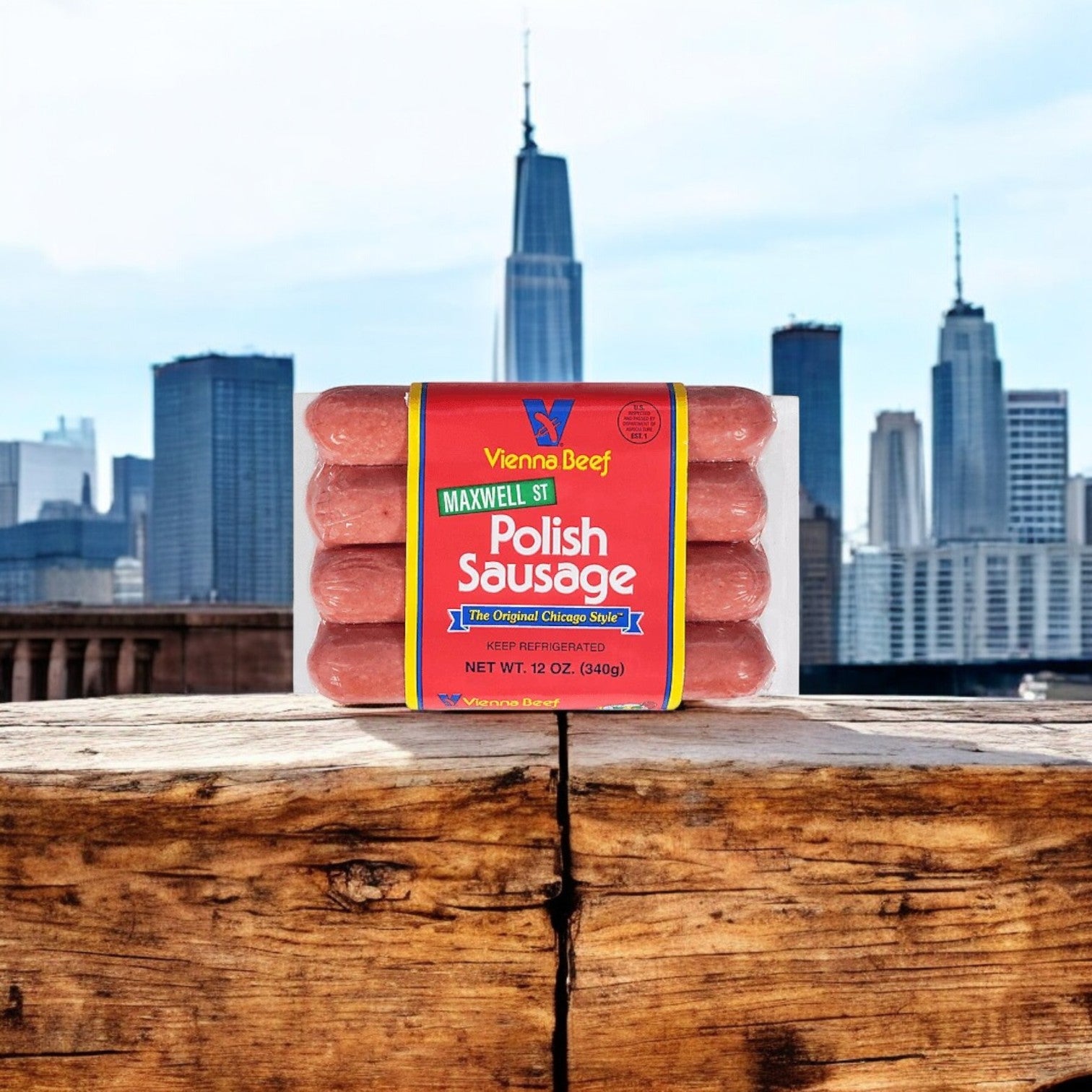 A package of Easy Lunches Chicago Classic Meat Combo – The Ultimate Windy City Feast! sits on a wooden surface with a city skyline behind it, perfect for creating an authentic Chicago-style meal.