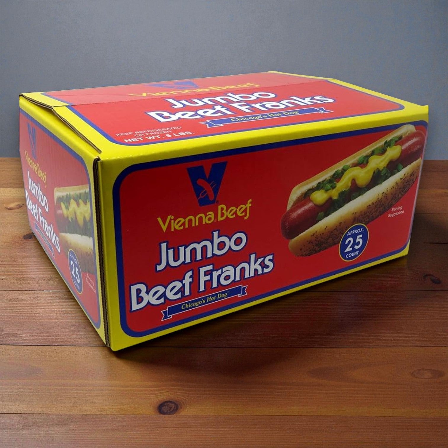 A Vienna Beef Hot Dog Kit box with 25 franks, poppy seed buns, mustard, and relish sits on a wooden surface, featuring an image of a Chicago-style hot dog. Perfect for making authentic Vienna Beef hot dogs at home.