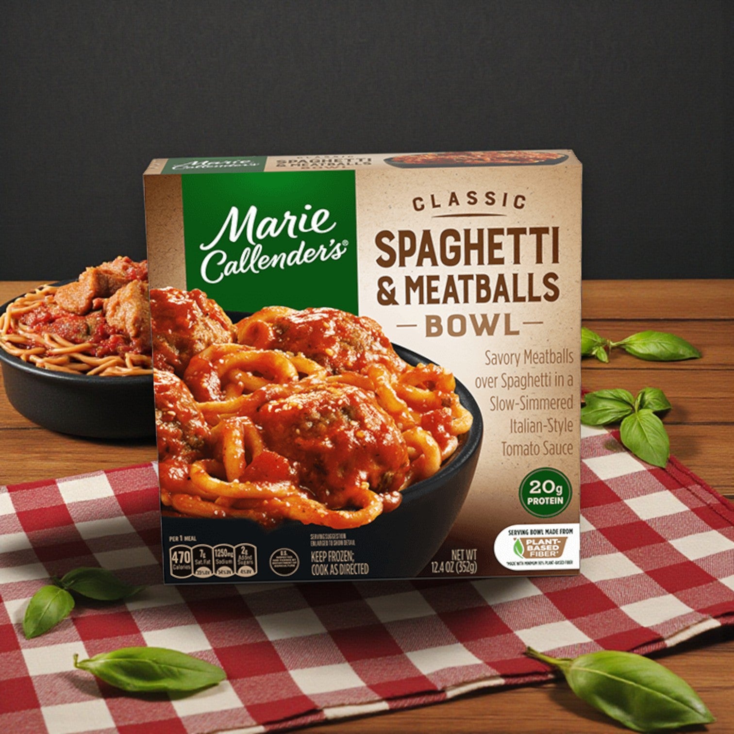 Marie Callender’s Comfort Classics Entrée Combo – 5 Delicious Meals sits on a checkered cloth, with basil leaves and a plated serving in the background.