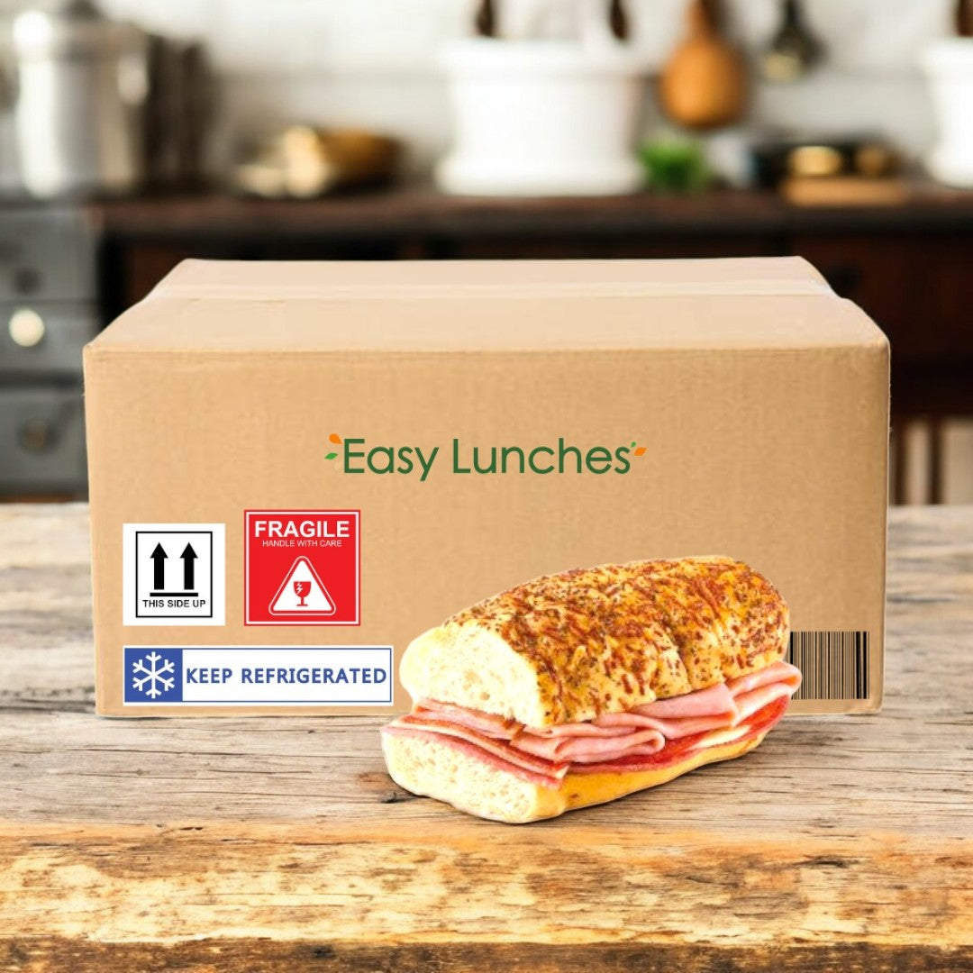 A cardboard E.A. Sween box labeled "Easy Lunches" with shipping and refrigeration stickers sits on a table, with a fresh Artisan Italian Style Sub—Smoked White Turkey & Provolone Cheese (1 case, 10 count)—in front of it. Ships frozen; 30-day cooler shelf life!.
