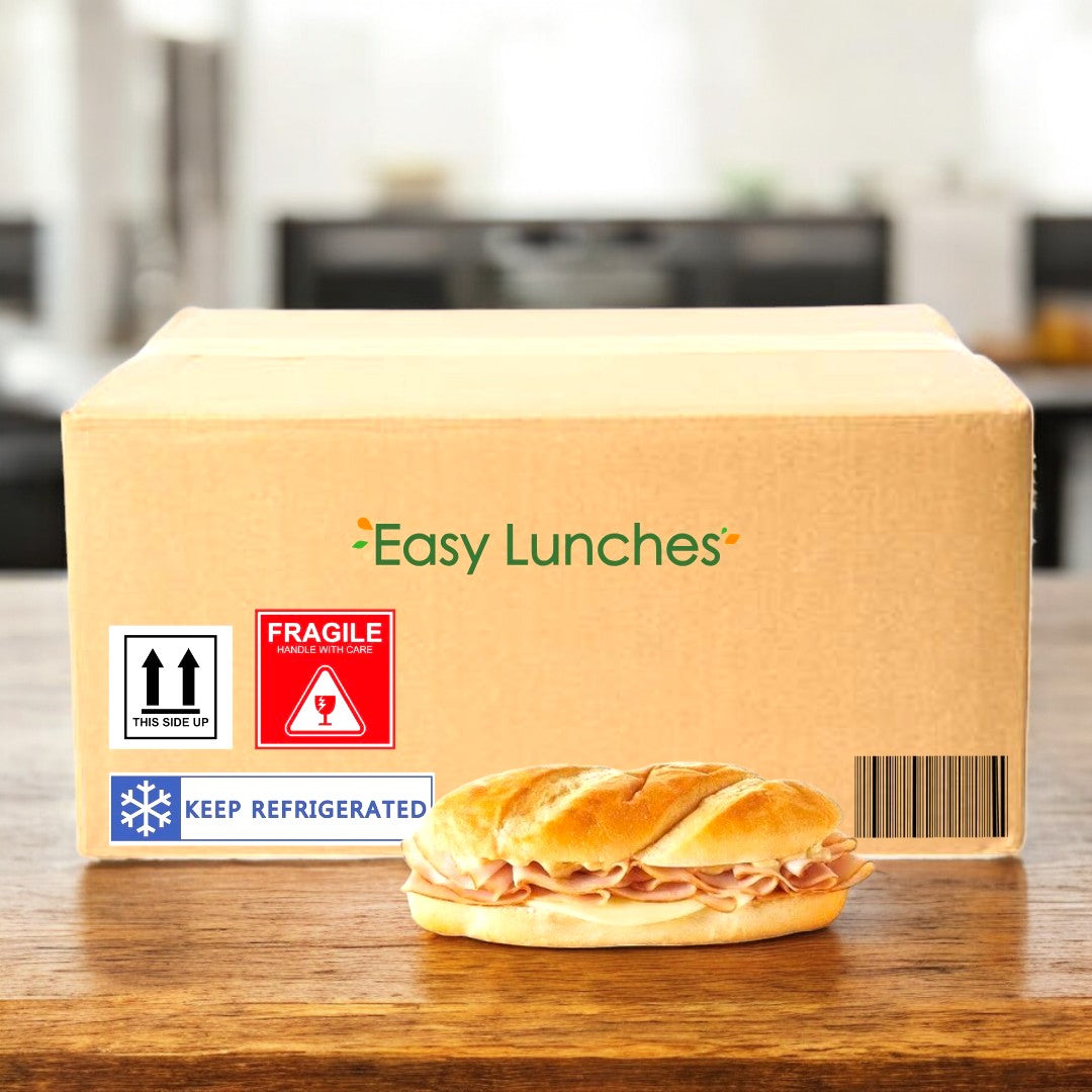 An E.A. Sween "Smoked White Turkey & Provolone Cheese Sub"—ships frozen with a 30-day cooler shelf life—sits in front of a labeled shipping box on a blurred kitchen countertop.
