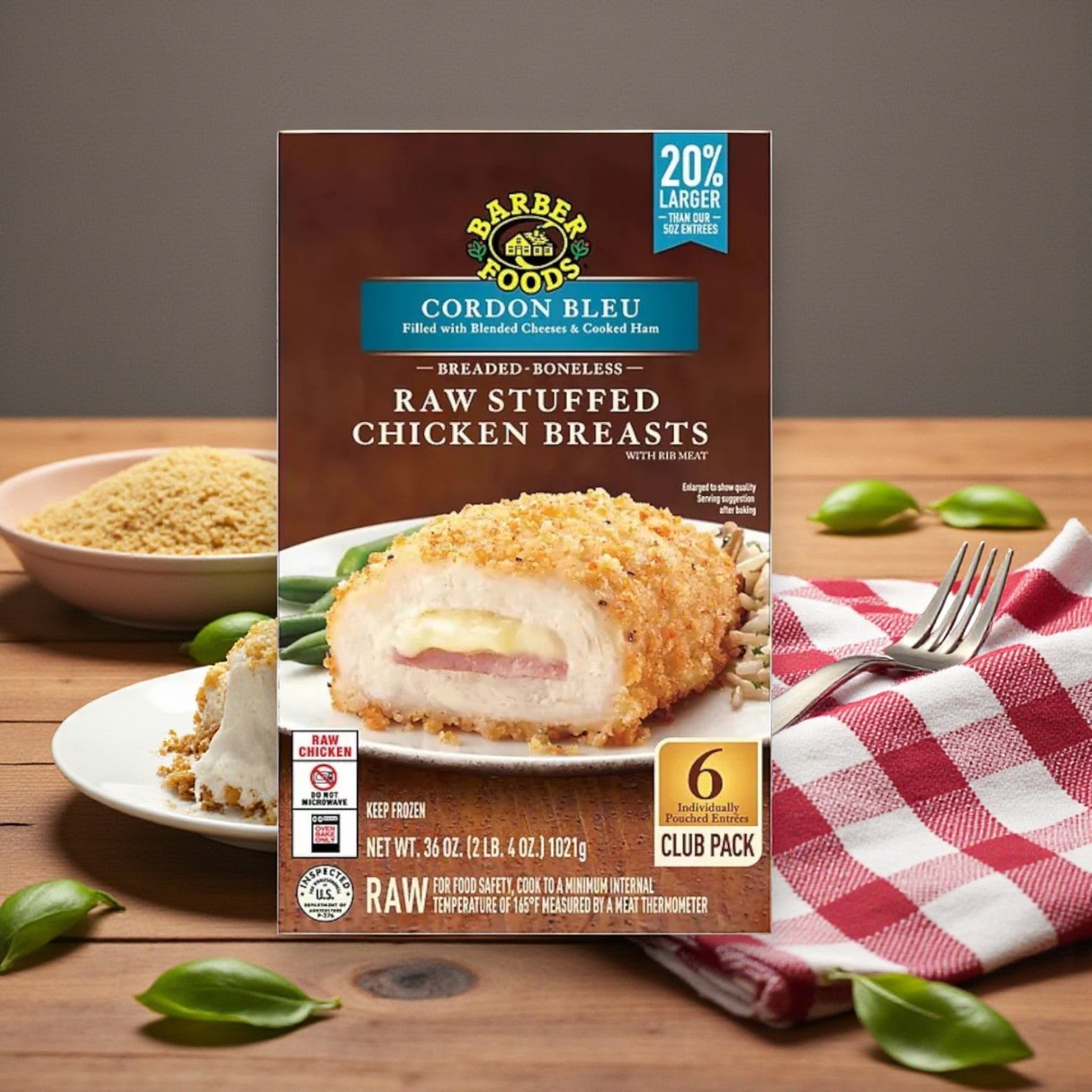 A Sam's Club Barber Foods Stuffed Chicken & Turkey Combo Pack – 3 Varieties! is displayed on a wooden table with breadcrumbs, basil leaves, and a red and white checkered napkin in the background.