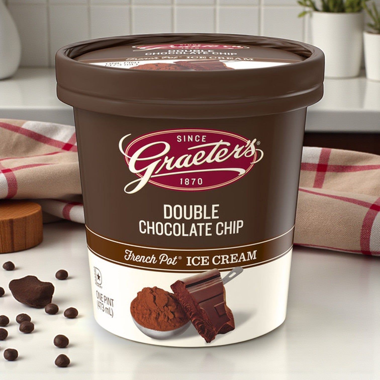 A 6-pint pack of Graeter’s Craft Ice Cream Combo sits on a kitchen counter next to chocolate pieces, cocoa powder, and coffee beans.