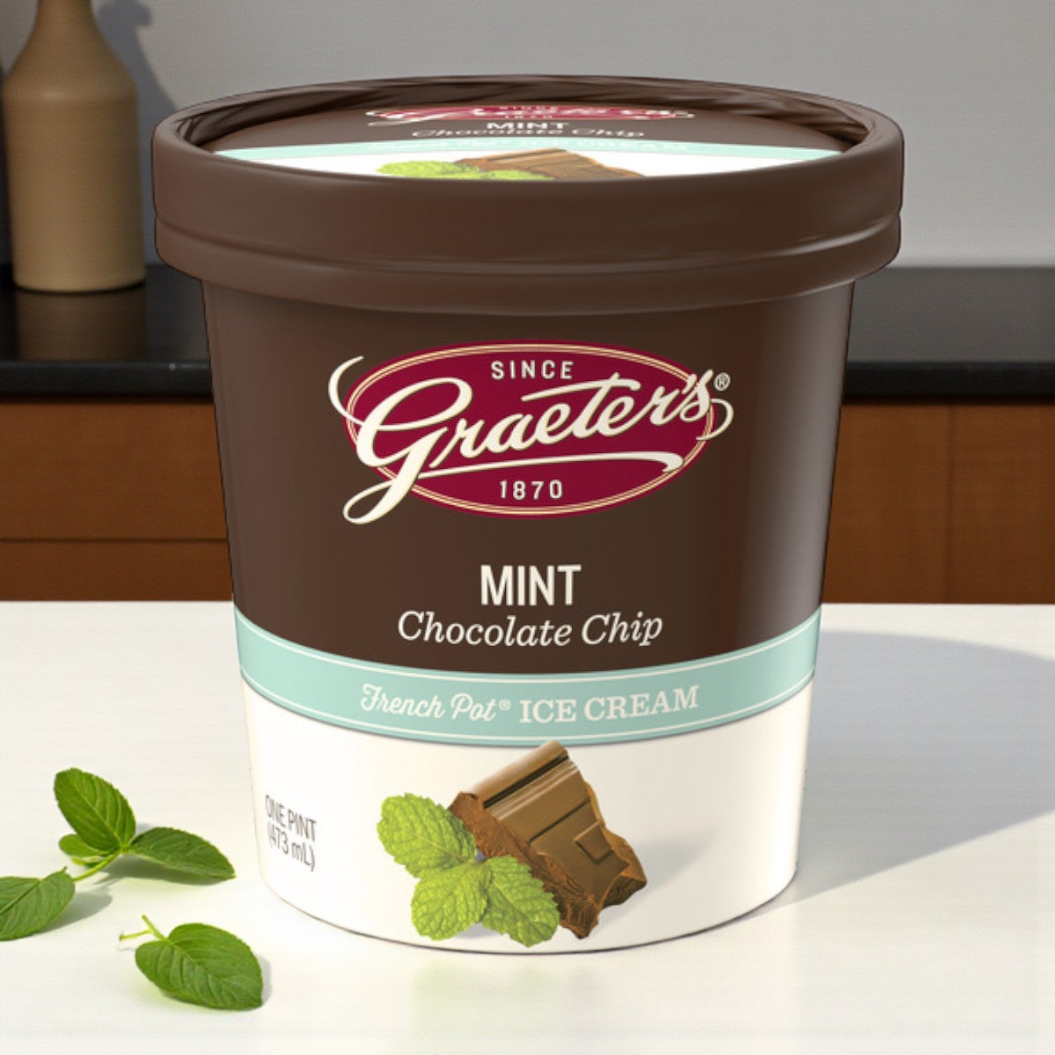 A Premium Ice Cream Lovers Combo pack from Easy Lunches, containing 6 total pints, sits on a counter with mint leaves and chocolate pieces beside it.