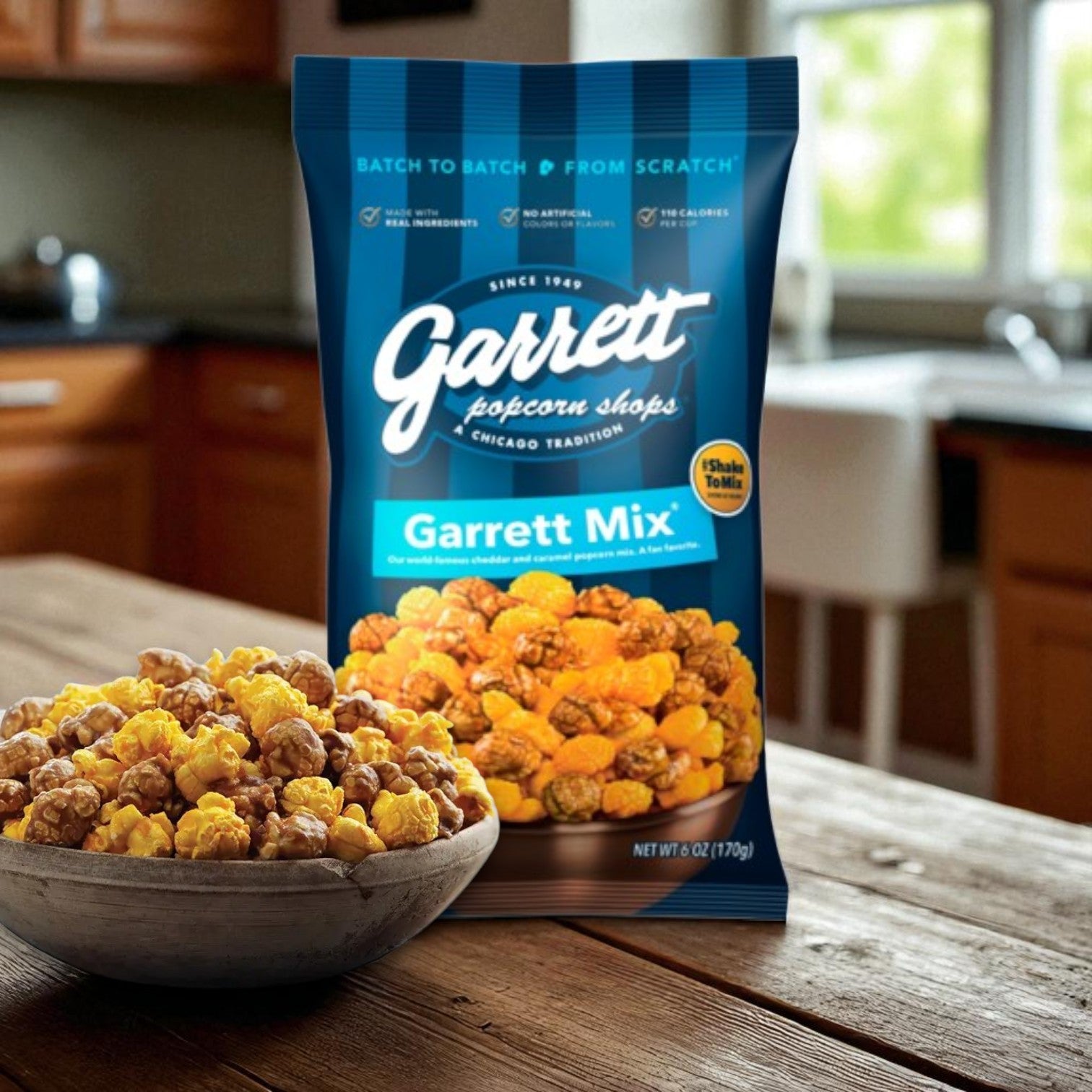 A Portillo's Famous Chocolate Cake & Garrett Popcorn Garrett Mix Combo – Sweet Chicago Treats! from Garrett sits on the counter, featuring caramel and cheese popcorn kernels for a classic taste of Chicago.