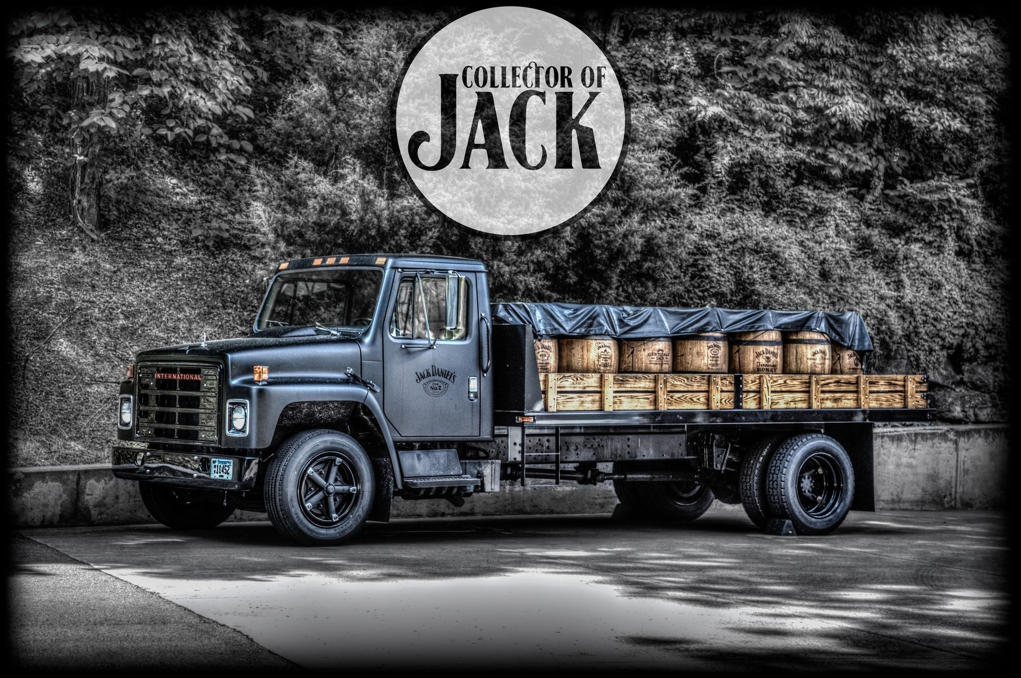 A vintage black truck loaded with wooden barrels, parked in front of a backdrop of trees. The words "Collector of Jack" are displayed on the image.