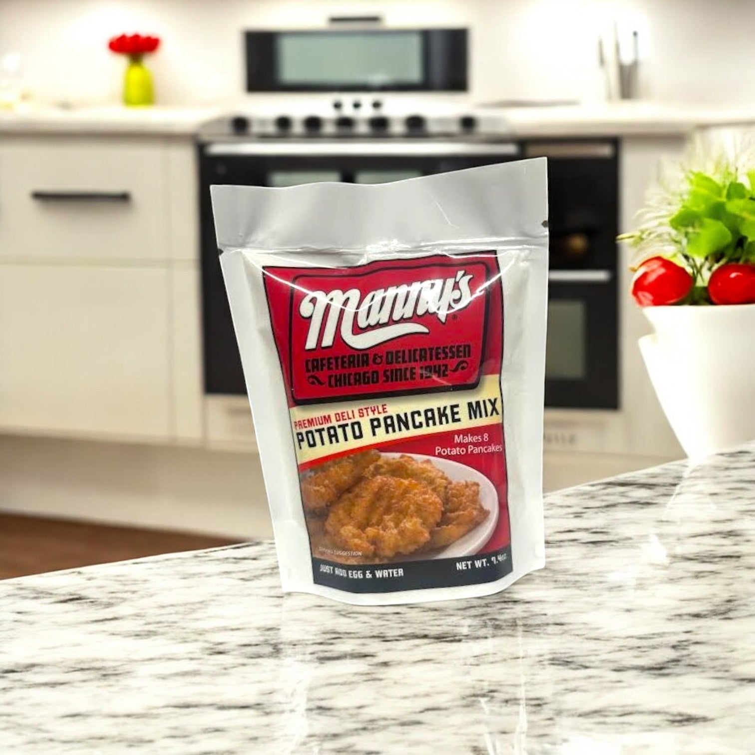 A Manny's 4 Count Combo! sits on the kitchen counter, evoking the taste of classic deli fare. In the blurred white kitchen background, you can almost imagine pairing it perfectly with corned beef sandwiches reminiscent of a Chicago deli.