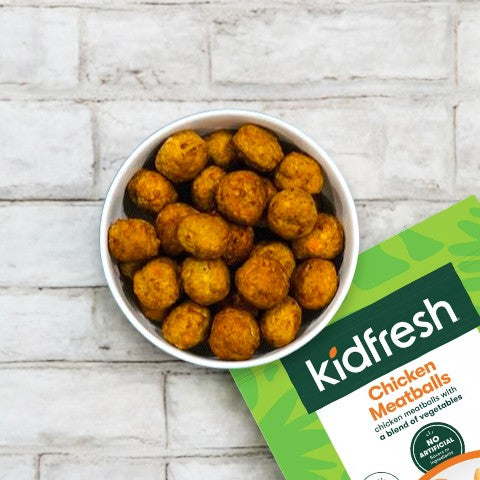 A bowl filled with Kidfresh Frozen Chicken Meatballs - 16.45 oz is shown next to a package labeled "Kidfresh Chicken Meatballs," offering a nutritious meal option with hidden veggies.