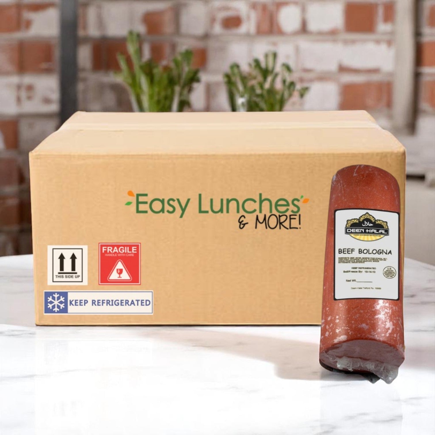 A box labeled "Easy Lunches & More!" sits on a counter beside a sealed package of Deen Halal Beef Bologna – Approx. 10.0 lb Each, from Deen Halal—ideal for quick meals or charcuterie boards.