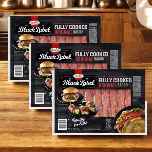 Three packages of Hormel Black Label Fully Cooked Bacon 10.5 oz., 72 ct, sit on a wooden surface, displaying images of smoky-flavored crispy strips. The "Ready to Eat!" label emphasizes the convenience of this premium pork product from Hormel, ideal for any meal.