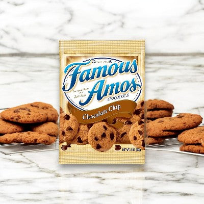 A package of Famous Amos Chocolate Chip Cookie - 2oz - 1 Count rests on a marble surface, surrounded by several loose cookies. Each cookie is perfectly crafted with premium semisweet chocolate chips, featuring crispy edges and chewy centers for an irresistible treat.