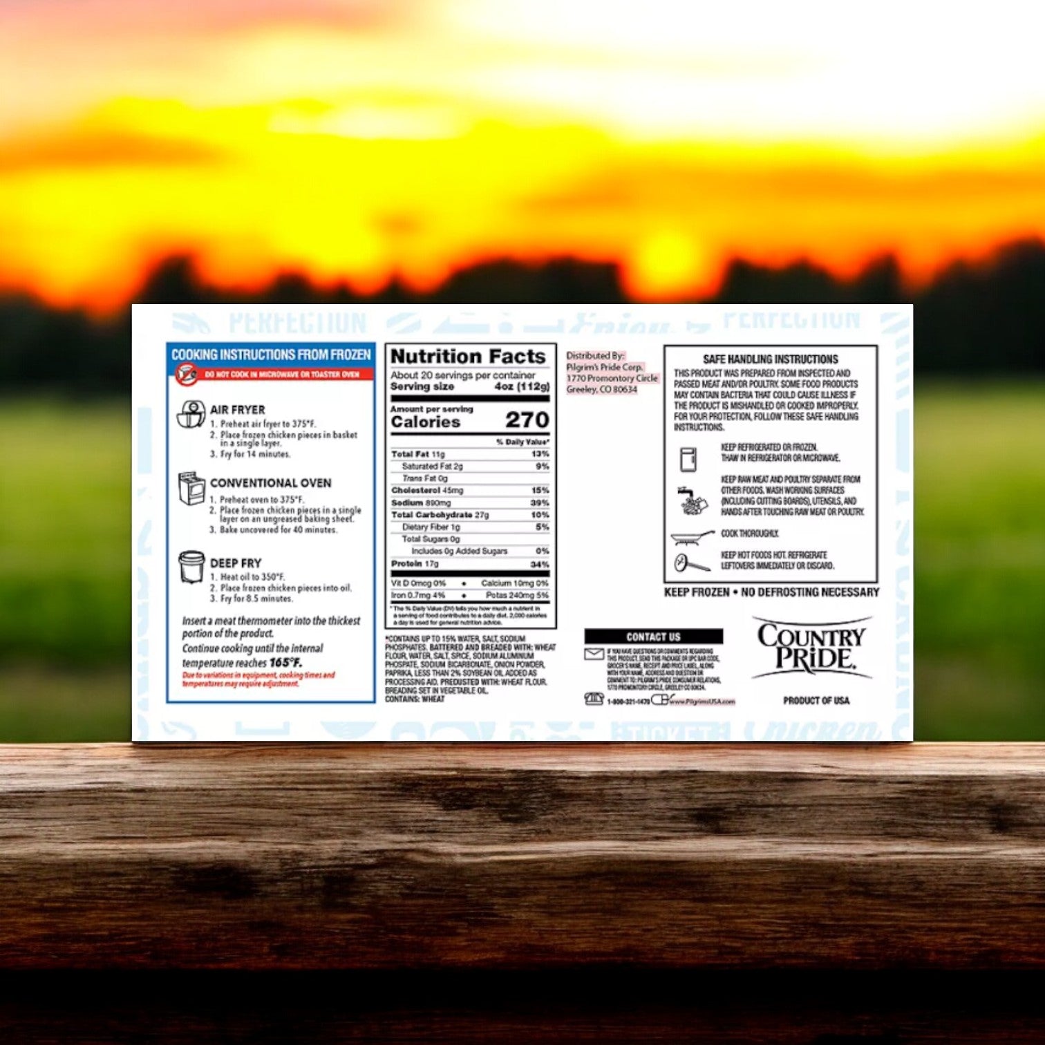 The packaging of the Country Pride Ready to Cook Chicken Breast Tenders, available in a 5 lbs. package with three boxes totaling 15 pounds, includes detailed cooking instructions, nutrition facts, and safety information. High in protein, it is set against a serene image of a blurred sunset over a grassy field.