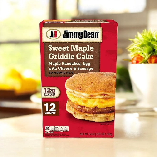 A case of Jimmy Dean Sweet Maple Griddle Cake Breakfast Sandwiches, featuring 12 count, is displayed on the kitchen counter, highlighting sweet maple griddle cakes that wrap around egg, cheese, and sausage with a touch of maple flavor.