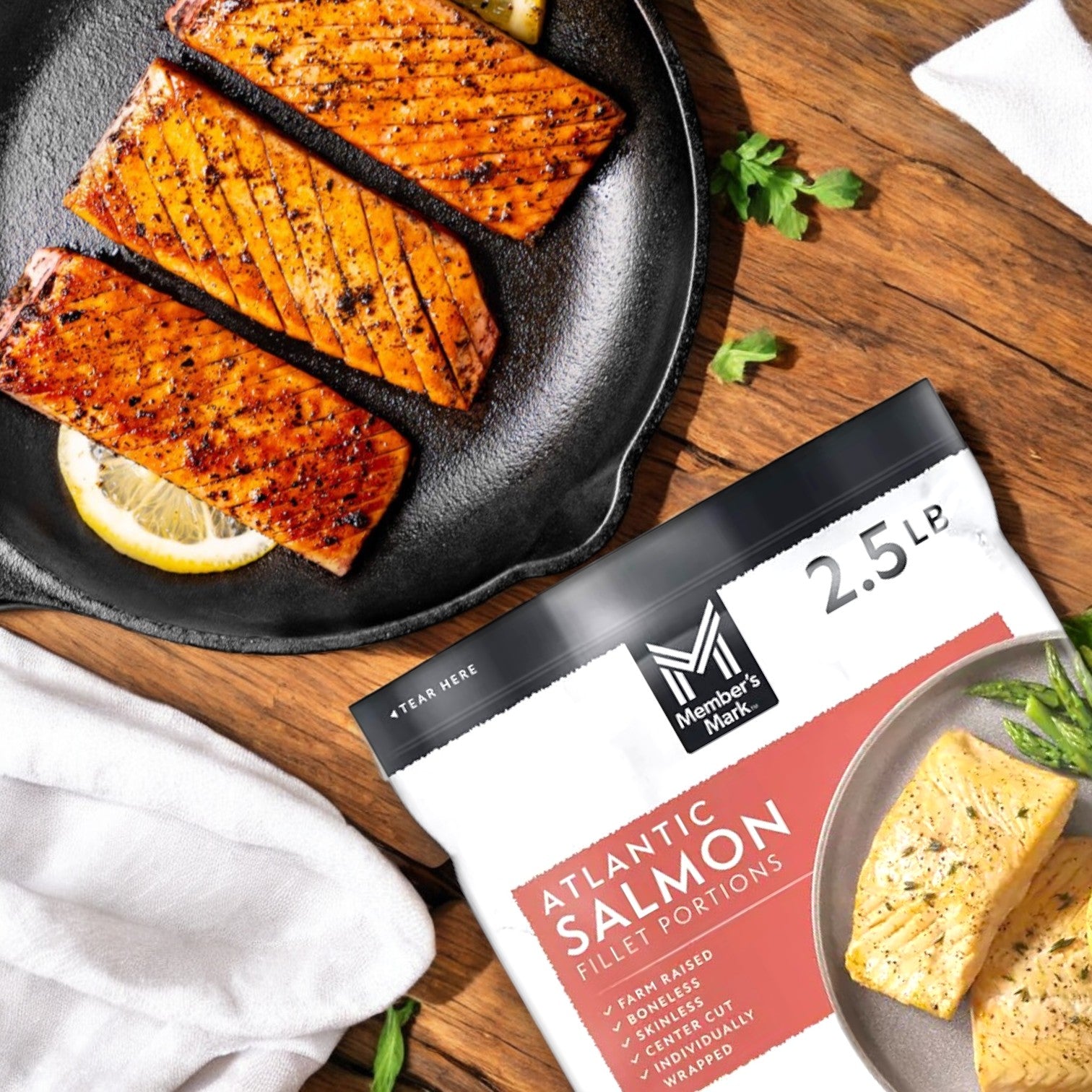 Member's Mark Salmon Fillet Portions, 4 oz. - Atlantic-3 Bags, are grilled on a skillet with lemon slices, highlighting their Omega-3 richness and sustainable sourcing. Enjoy free shipping!.