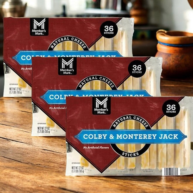 Three packs of Easy Lunches Member's Mark Colby and Monterey Jack Cheese Sticks (36 ct each) rest on a wooden surface—ideal grab-and-go snacks for any occasion.