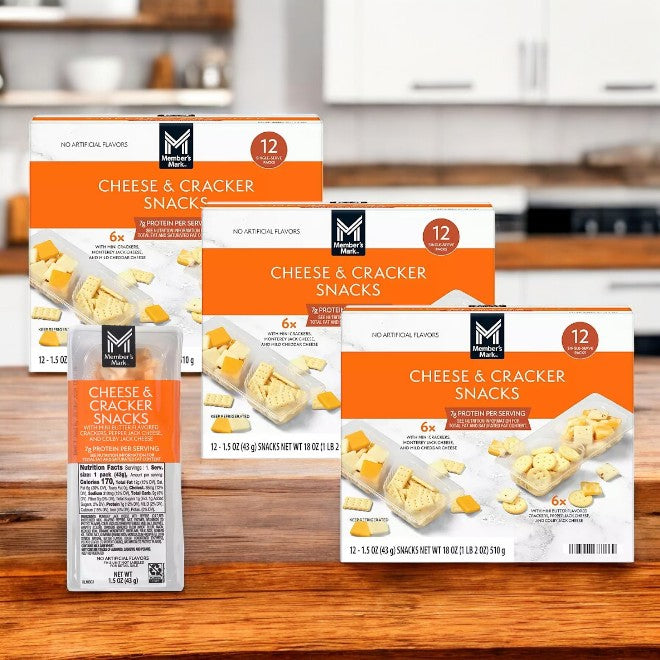 Four boxes of Member's Mark Cheese and Cracker Snacks, a gluten-free and protein-packed snack, are arranged on a wooden surface with one package invitingly placed in front.