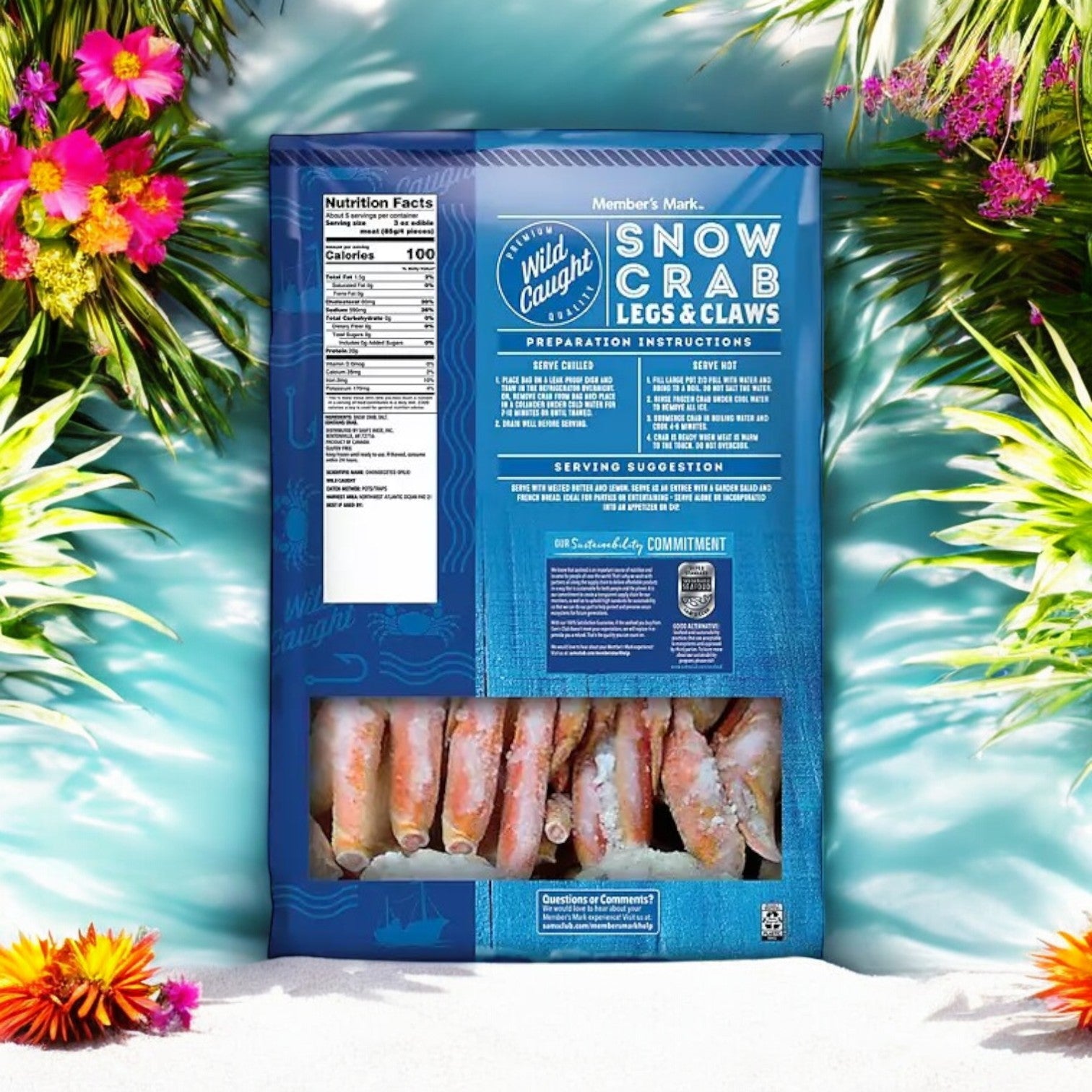 A 2 lb. bag of Member's Mark Wild Caught Snow Crab Legs and Claws stands upright on sand, surrounded by tropical flowers and greenery, creating the perfect seafood feast ambiance.