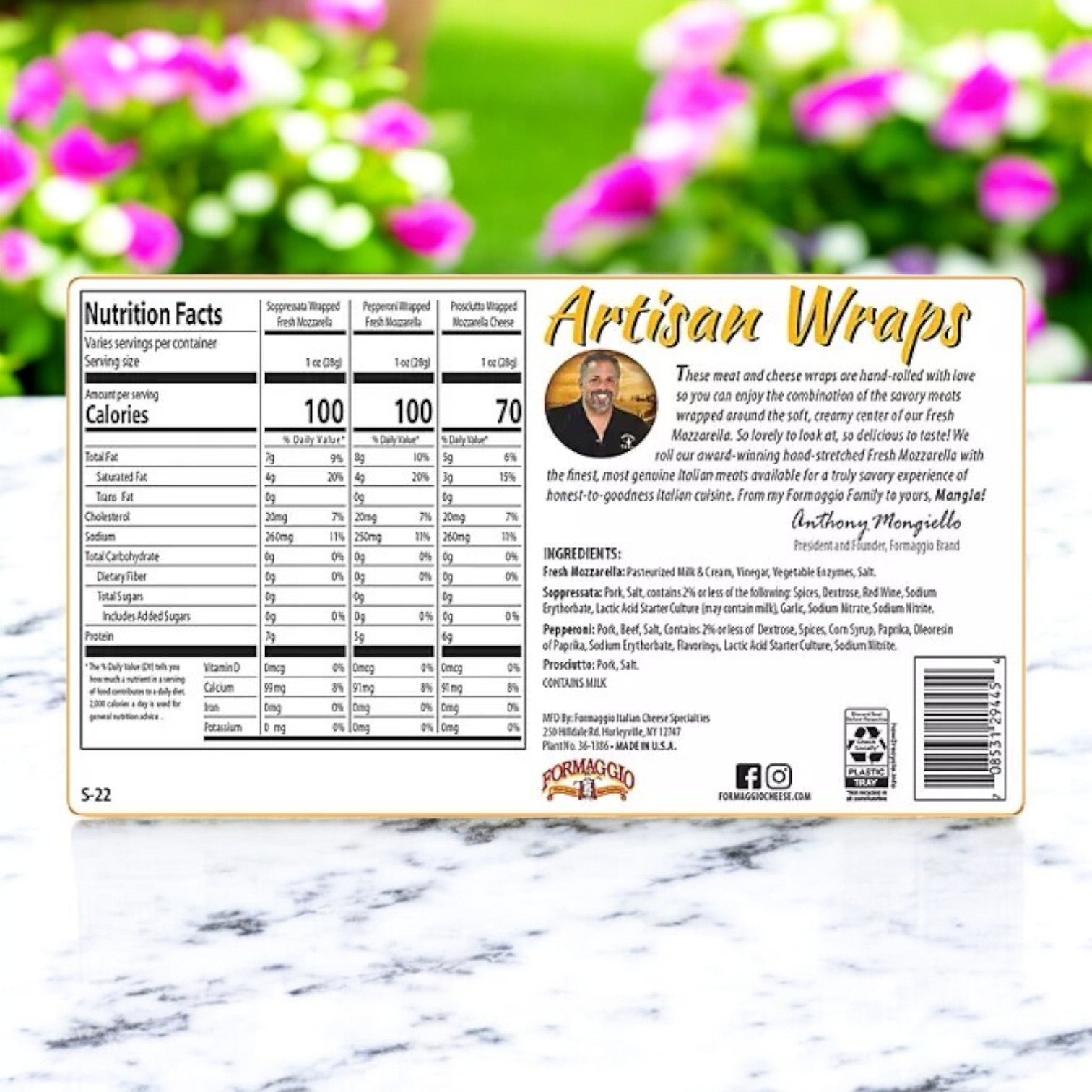 Easy Lunches' Formaggio Cheese Artisan Meat & Mozzarella Variety Wraps, 22 oz. - 3 Count, displayed on marble with nutrition facts and ingredients; features creamy mozzarella cheese amidst blurred greenery and flowers.